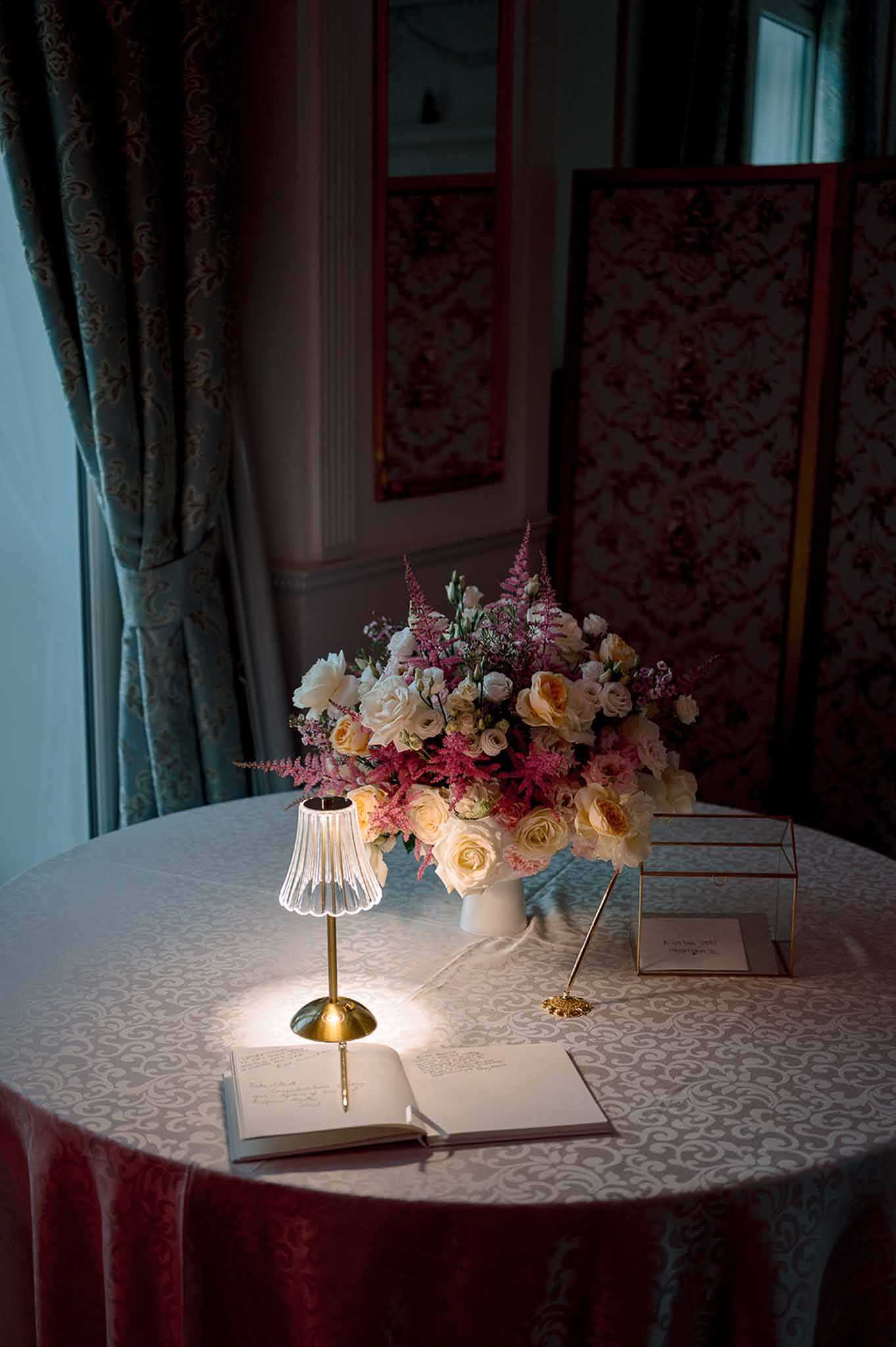 Wedding reception table setting in a garden with white roses