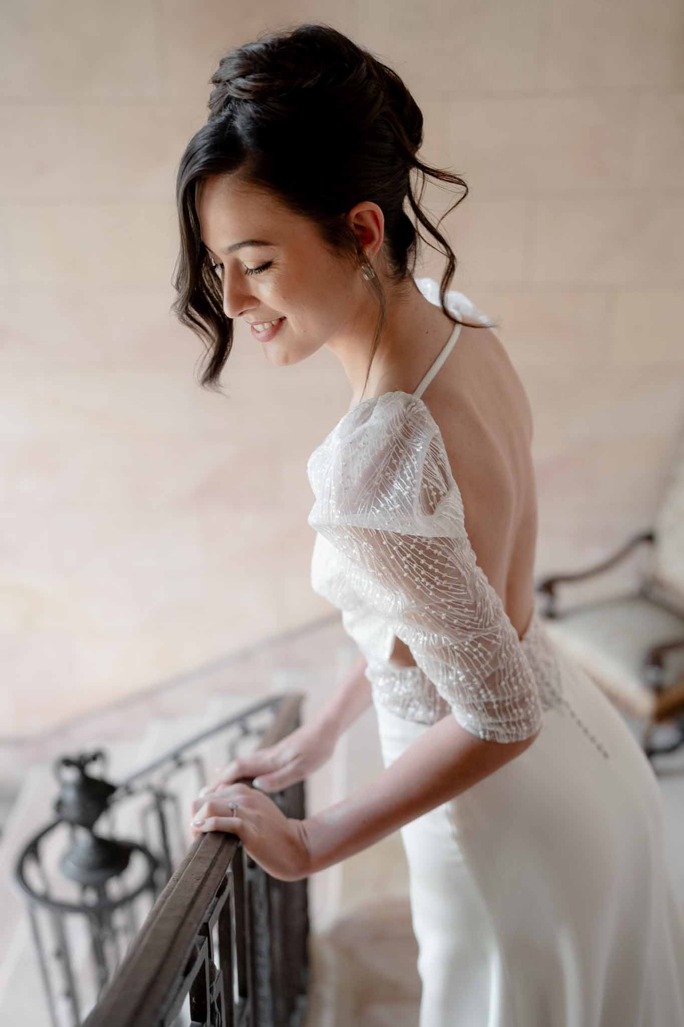 Bride wearing sparkly open-back wedding dress at Chateau d'Arcelot