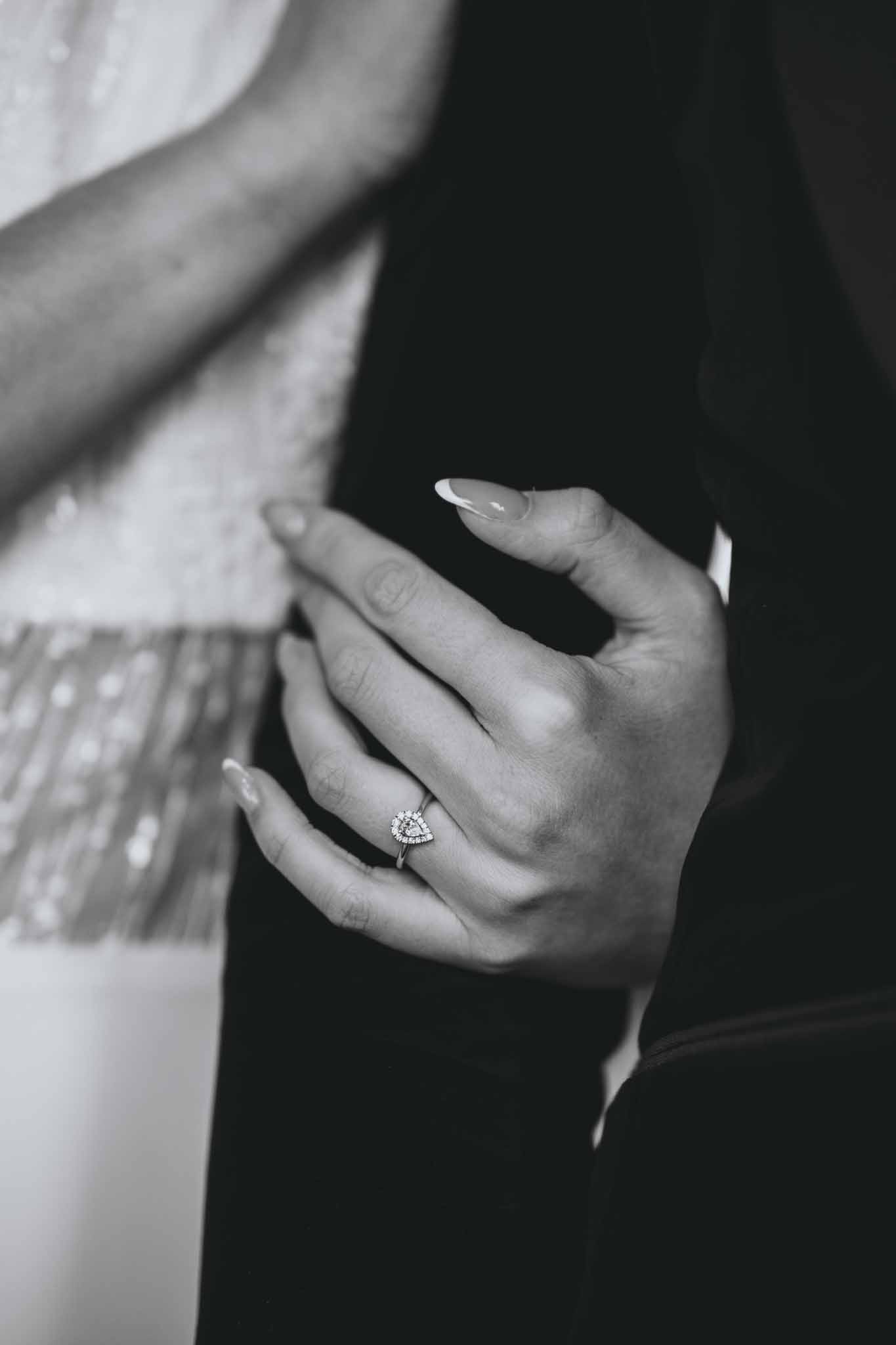 Close-up of bride's hands showing her engagement ring