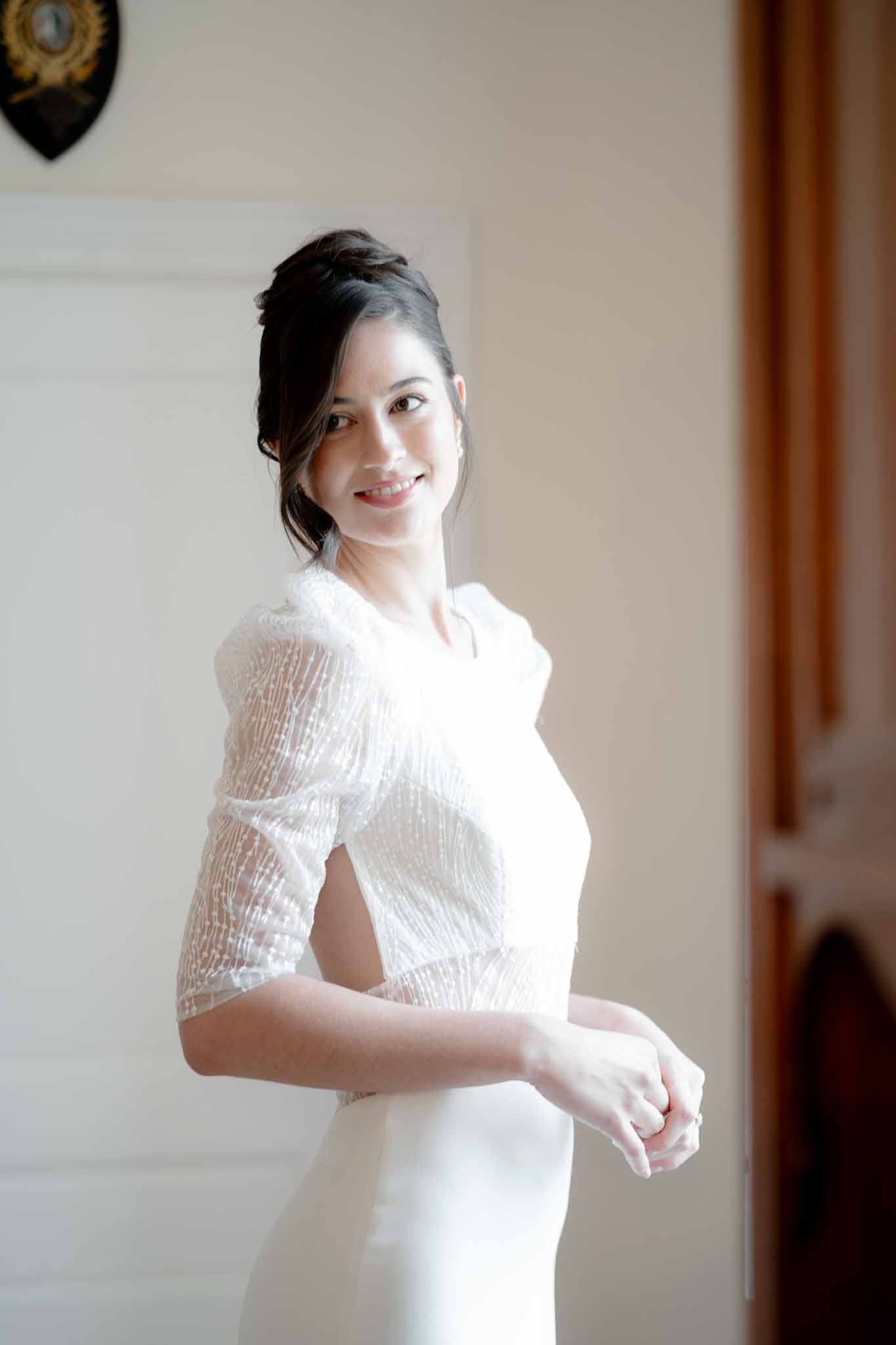 Bride's elegant updo hairstyle with soft side bangs