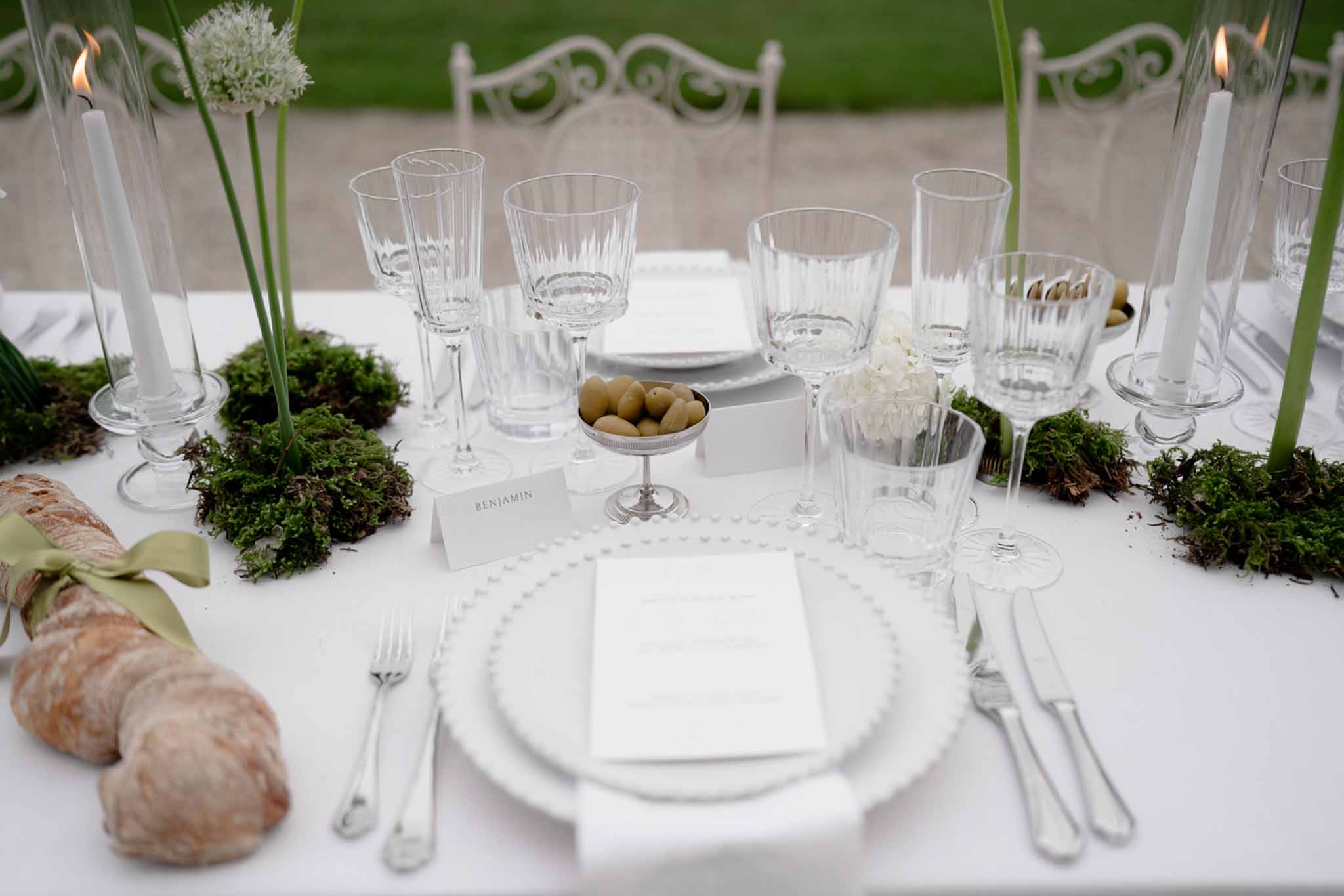 Reception table with food, floral centerpiece, and lit candles