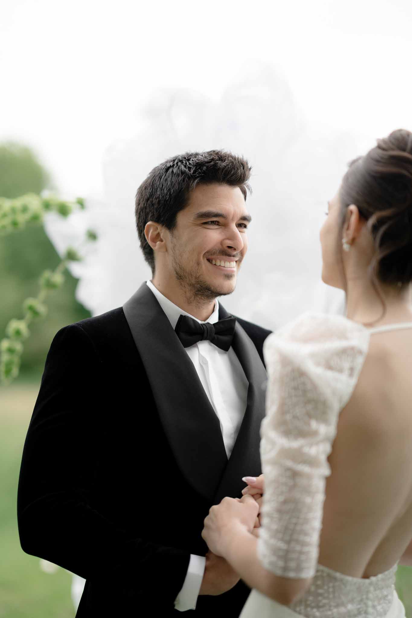 Close-up of groom holding bride's hands during ceremony vows