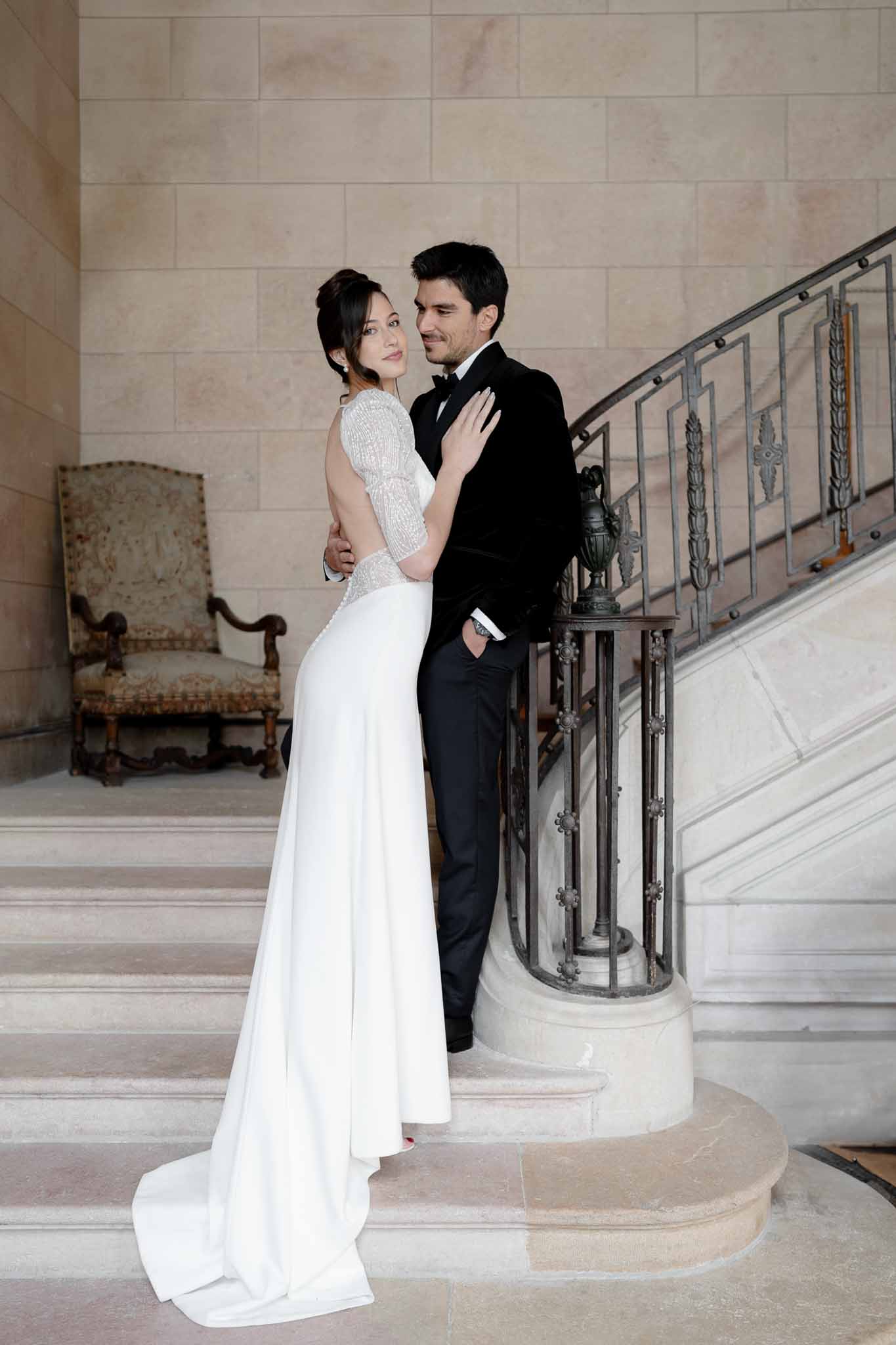 Couple hugging on the stone staircase inside Chateau d'Arcelot