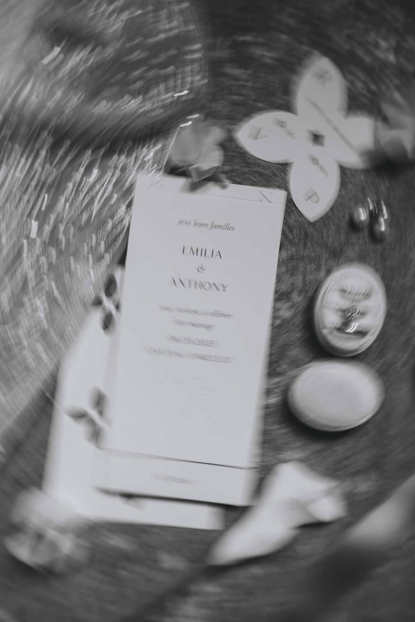 Soft focus view of minimalist invitation suite with accessories