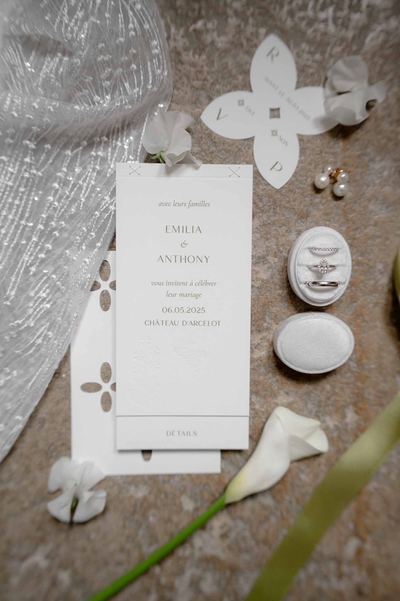 Minimalist wedding invitation suite arranged with bridal accessories