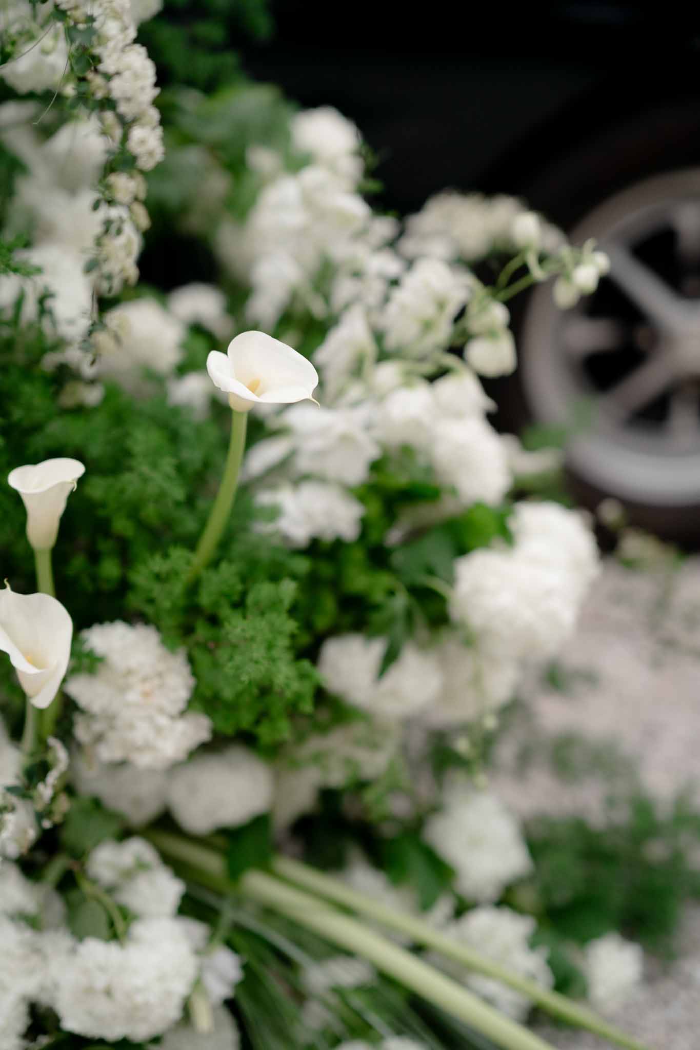 Close-up of white floral arrangement with sweet peas and calla lilies