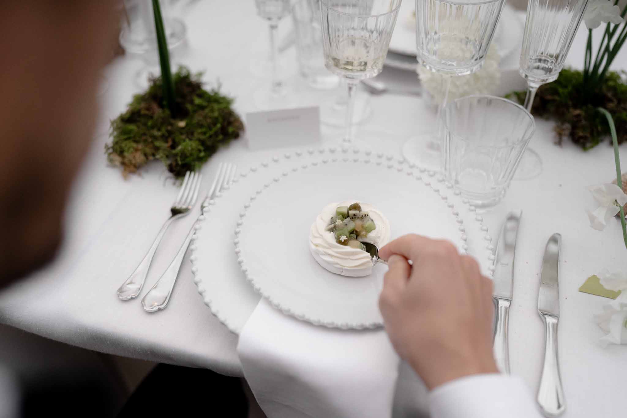 Groom enjoying food at the reception table