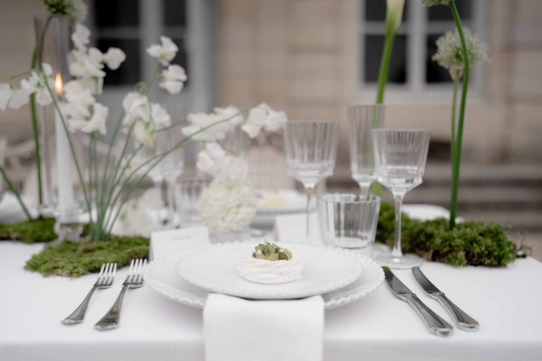 Reception table showing plated food and complete tableware setting
