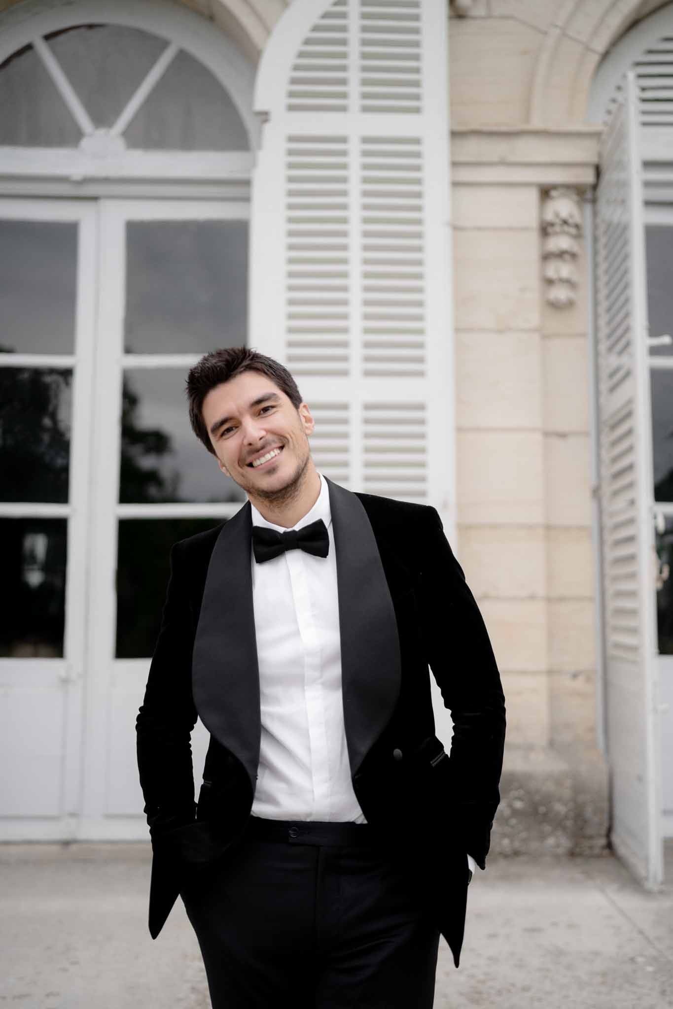 Portrait of groom in black velvet suit and bow tie