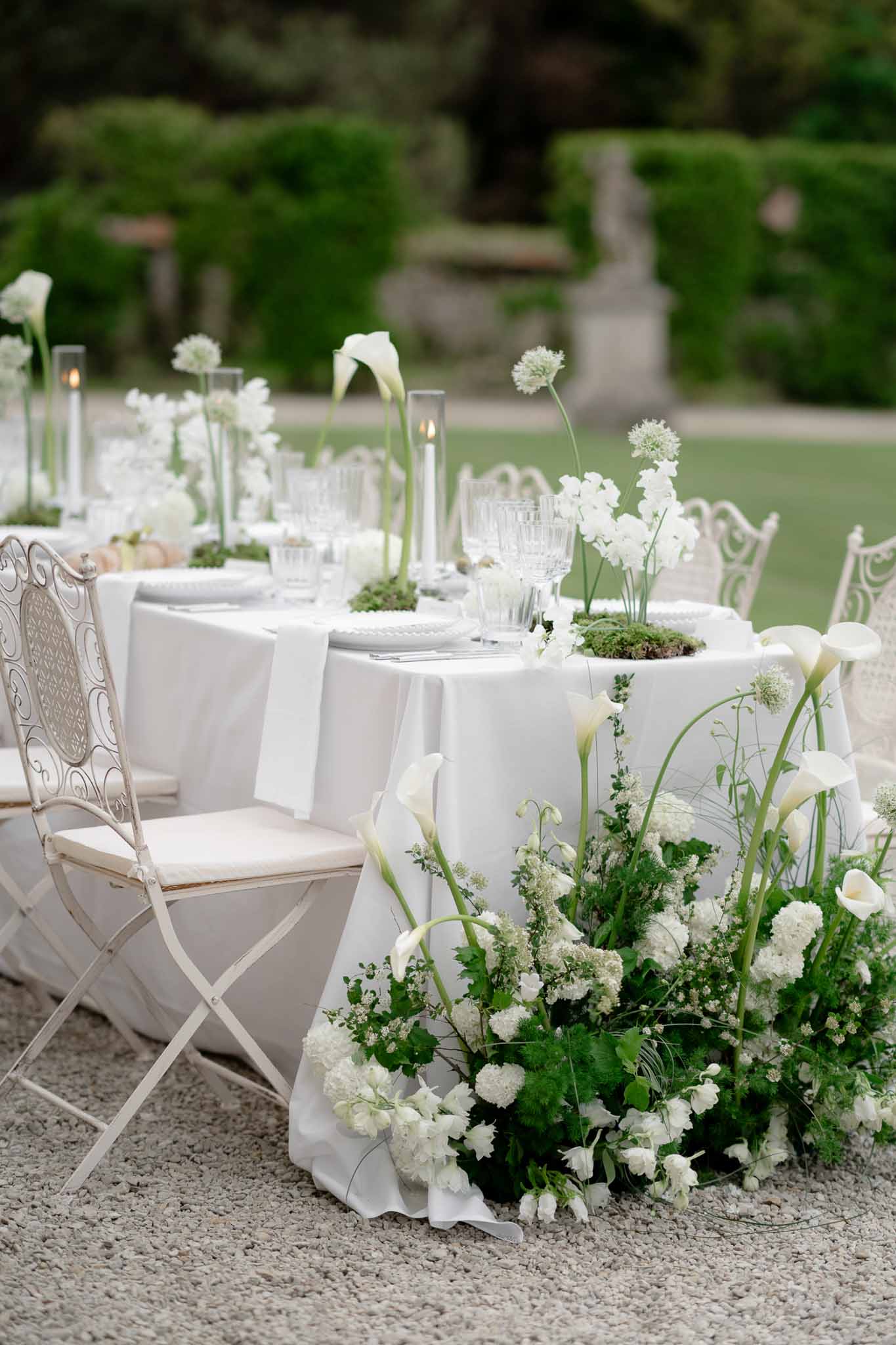 Elegant reception tablescape with floral centerpiece in the garden at Chateau d'Arcelot