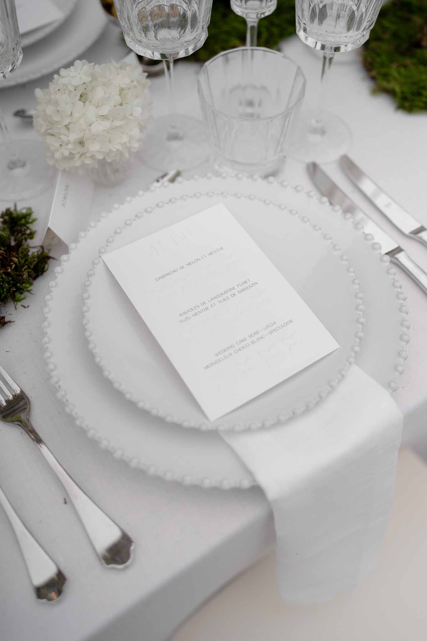 Elegant place setting with minimalist menu card and silverware
