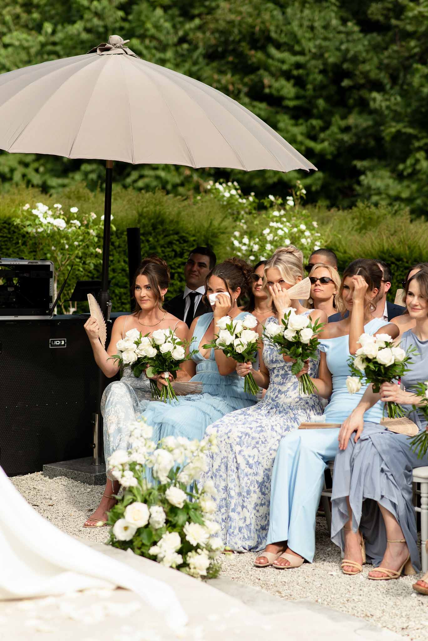 Couple exchanging vows in a garden with white roses