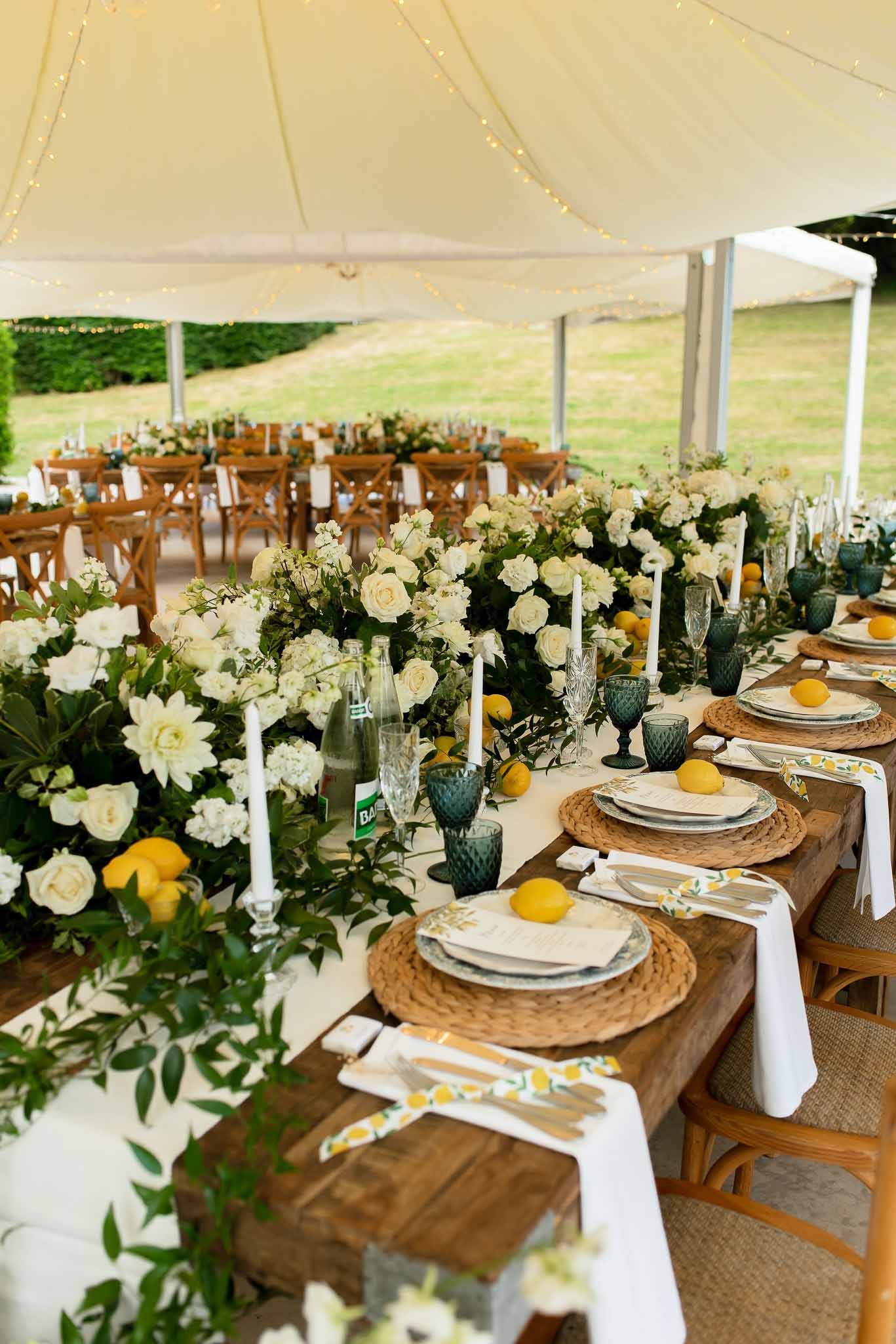 Wedding reception table setting in a garden with white roses