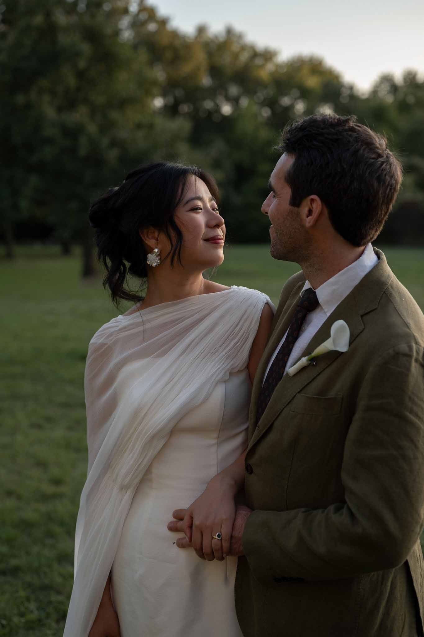 Couple gazing at each other in warm golden hour light in Provençal garden