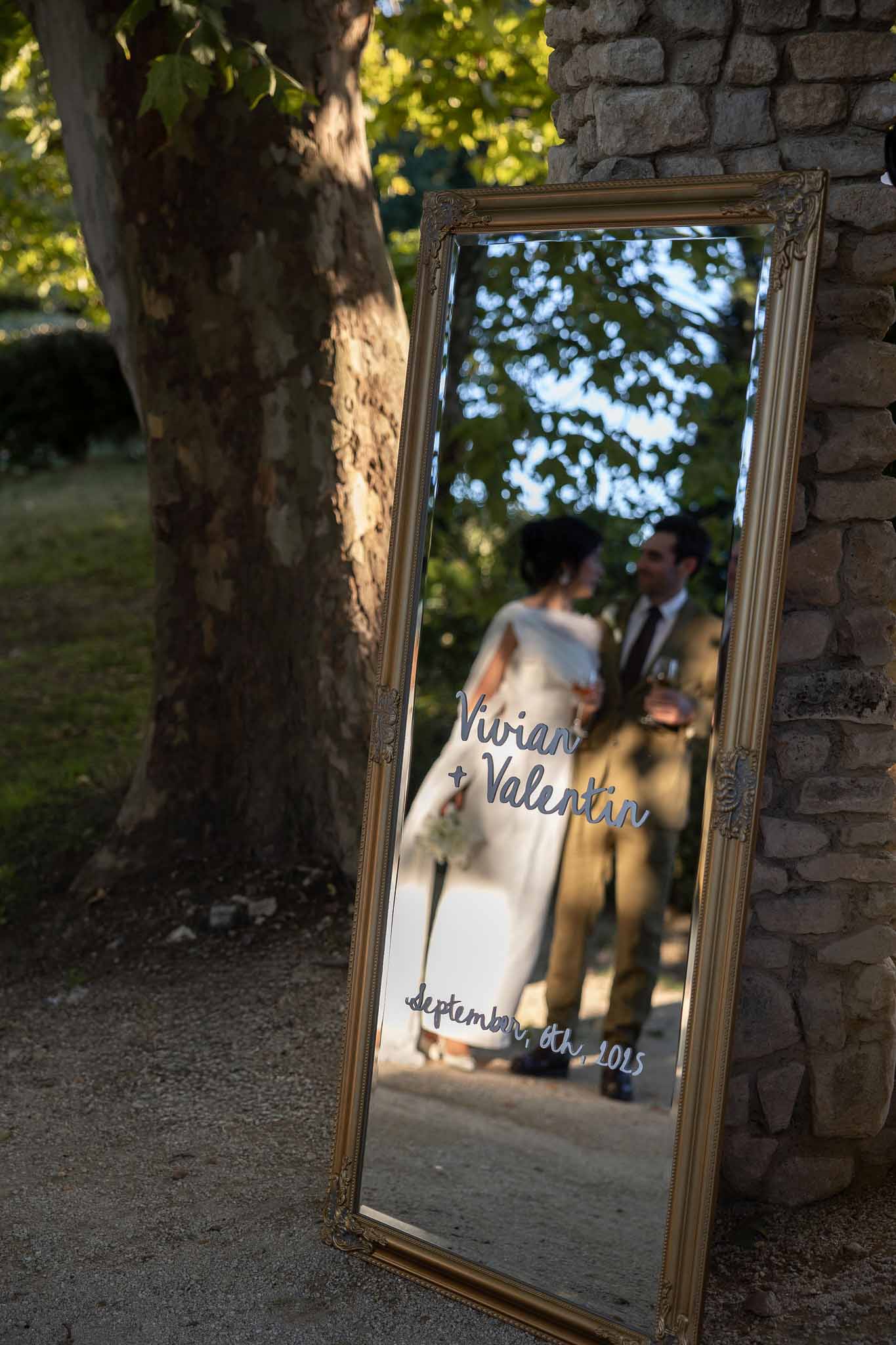 Gold vintage mirror with wedding signage at Notre-Dame de Conil reception
