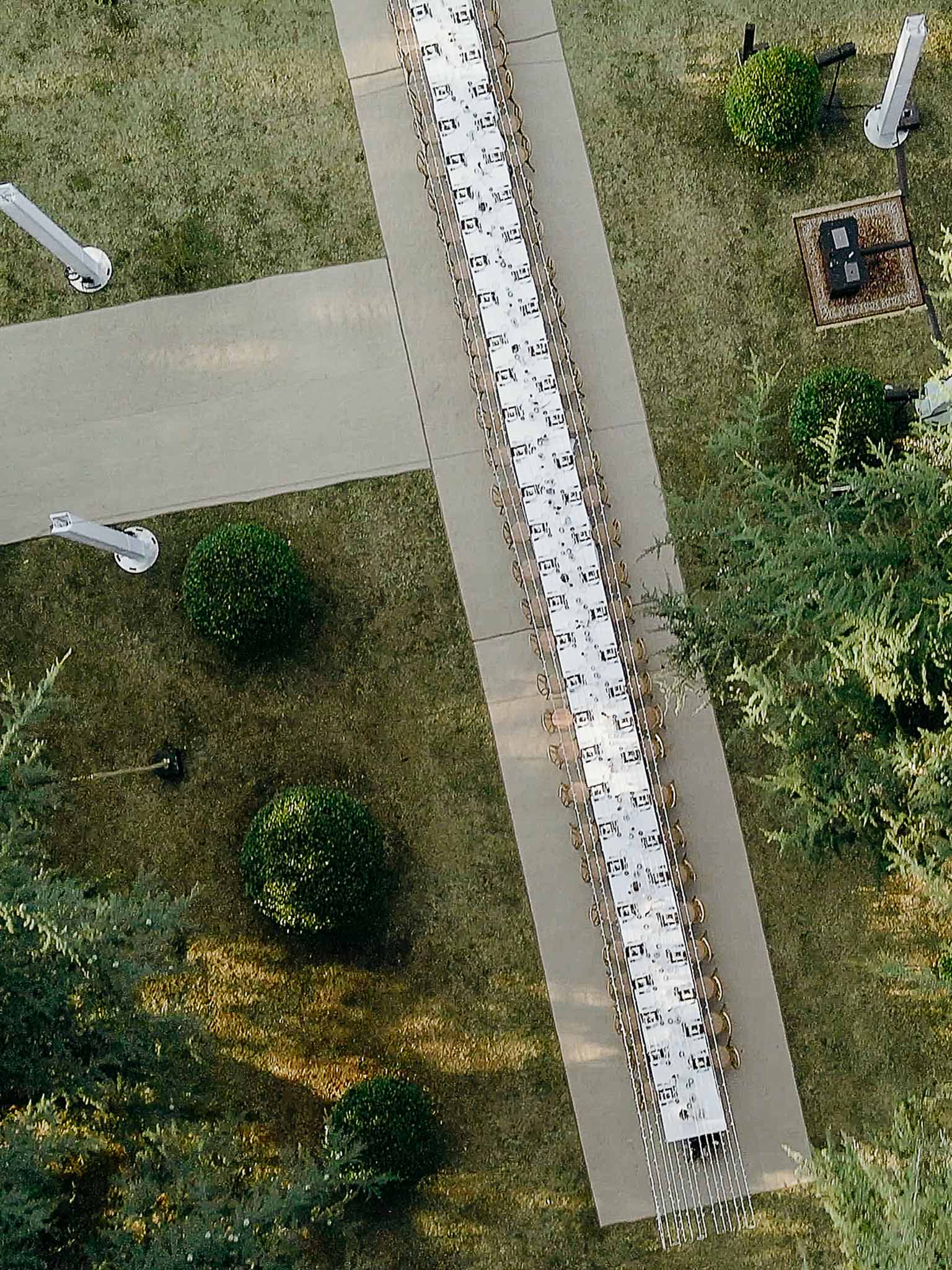 Aerial shot of the long reception table set in the garden at Domaine de Perrotin