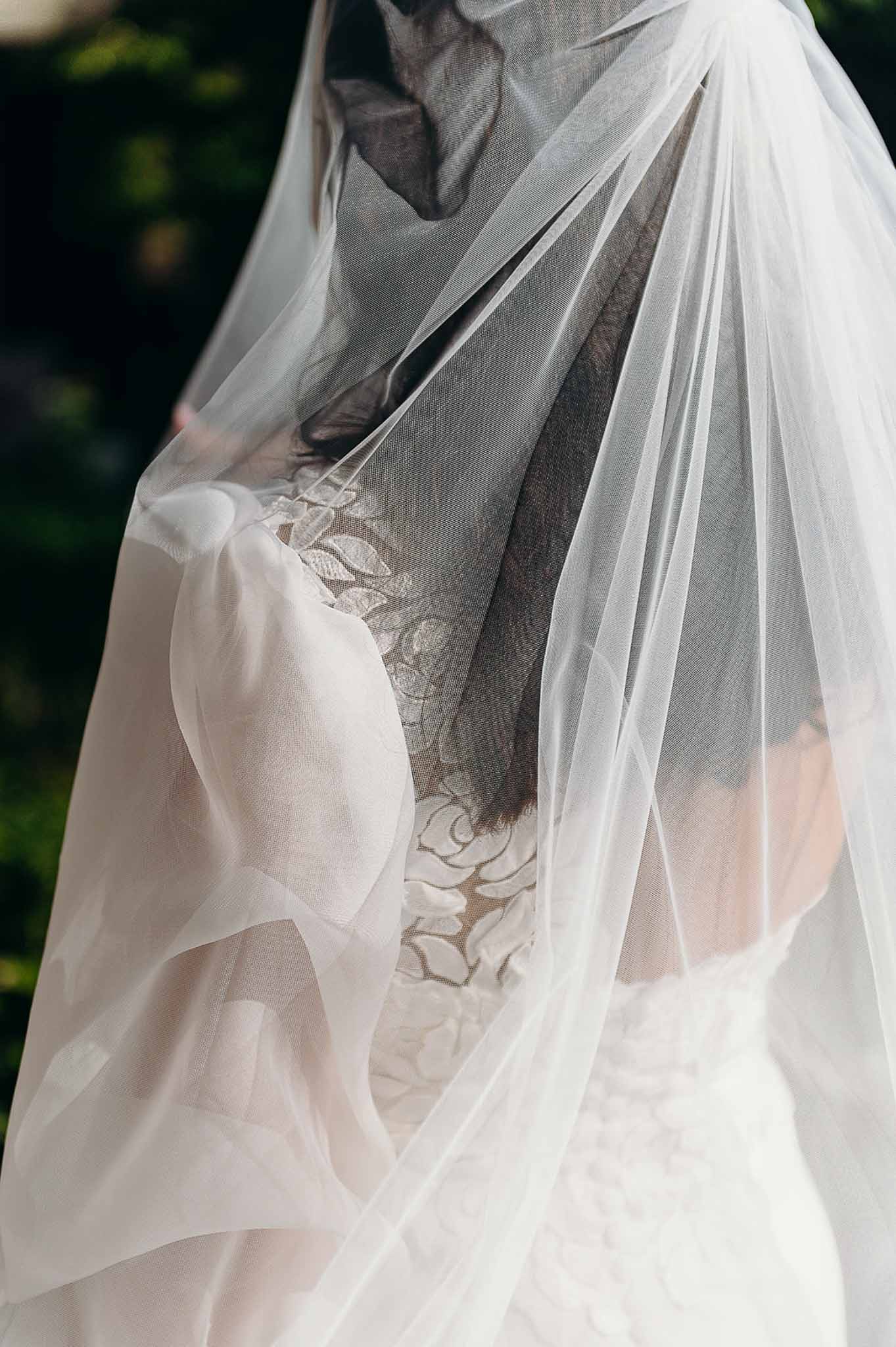 Bride's one-shoulder dress with puff sleeves at Domaine de Perrotin