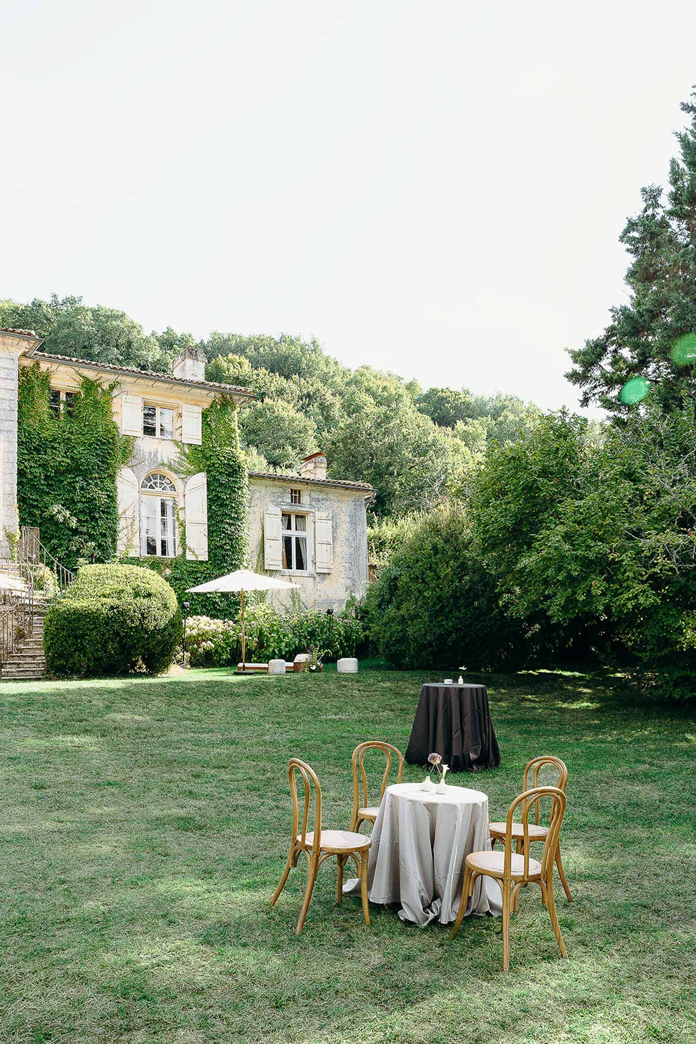 Garden area with tables and chairs set up at Domaine de Perrotin