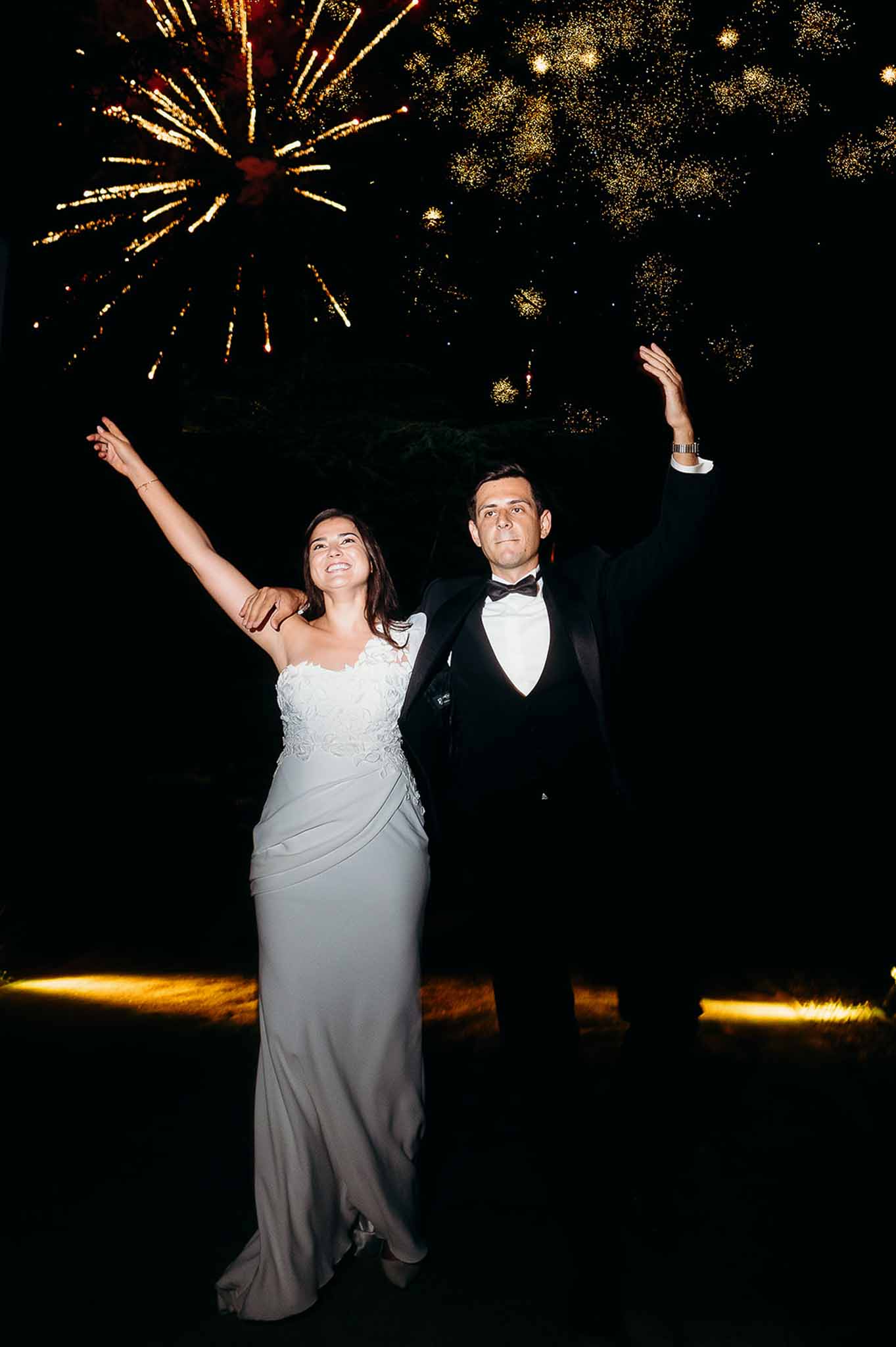 Fireworks bursting over bride and groom dancing at the reception at Domaine de Perrotin