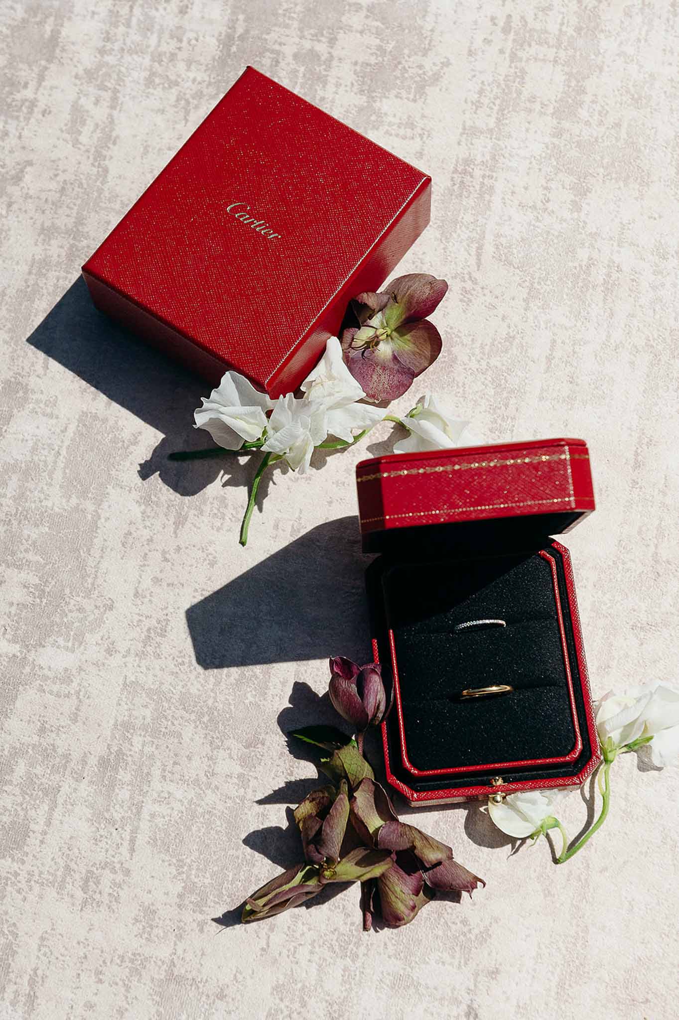 Flat lay of diamond ring in a red Cartier box at Domaine de Perrotin