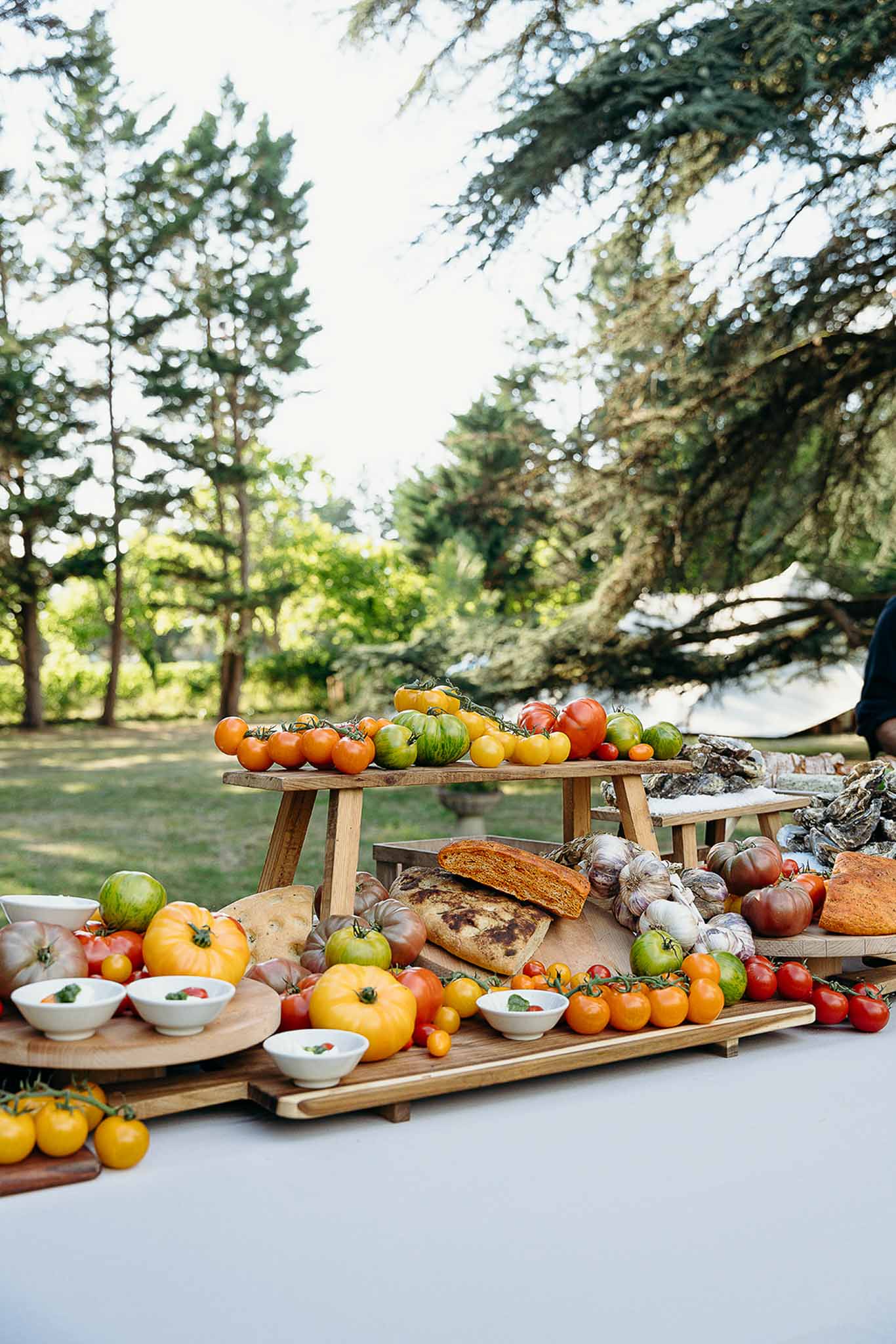 Buffet table set in the garden during golden hour at Domaine de Perrotin