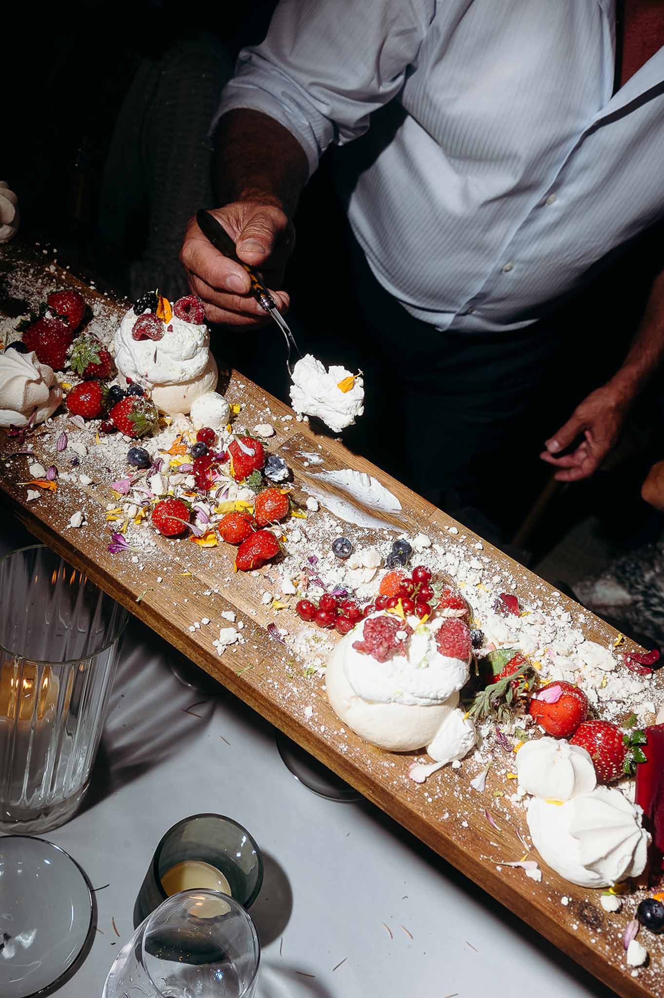 Waiter serving pastries at the reception food buffet at Domaine de Perrotin