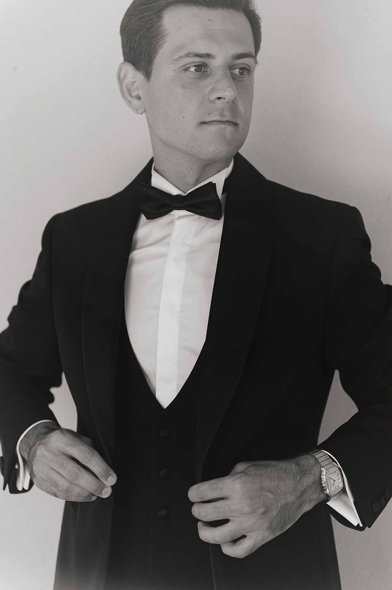 Groom in black tuxedo getting ready at Domaine de Perrotin