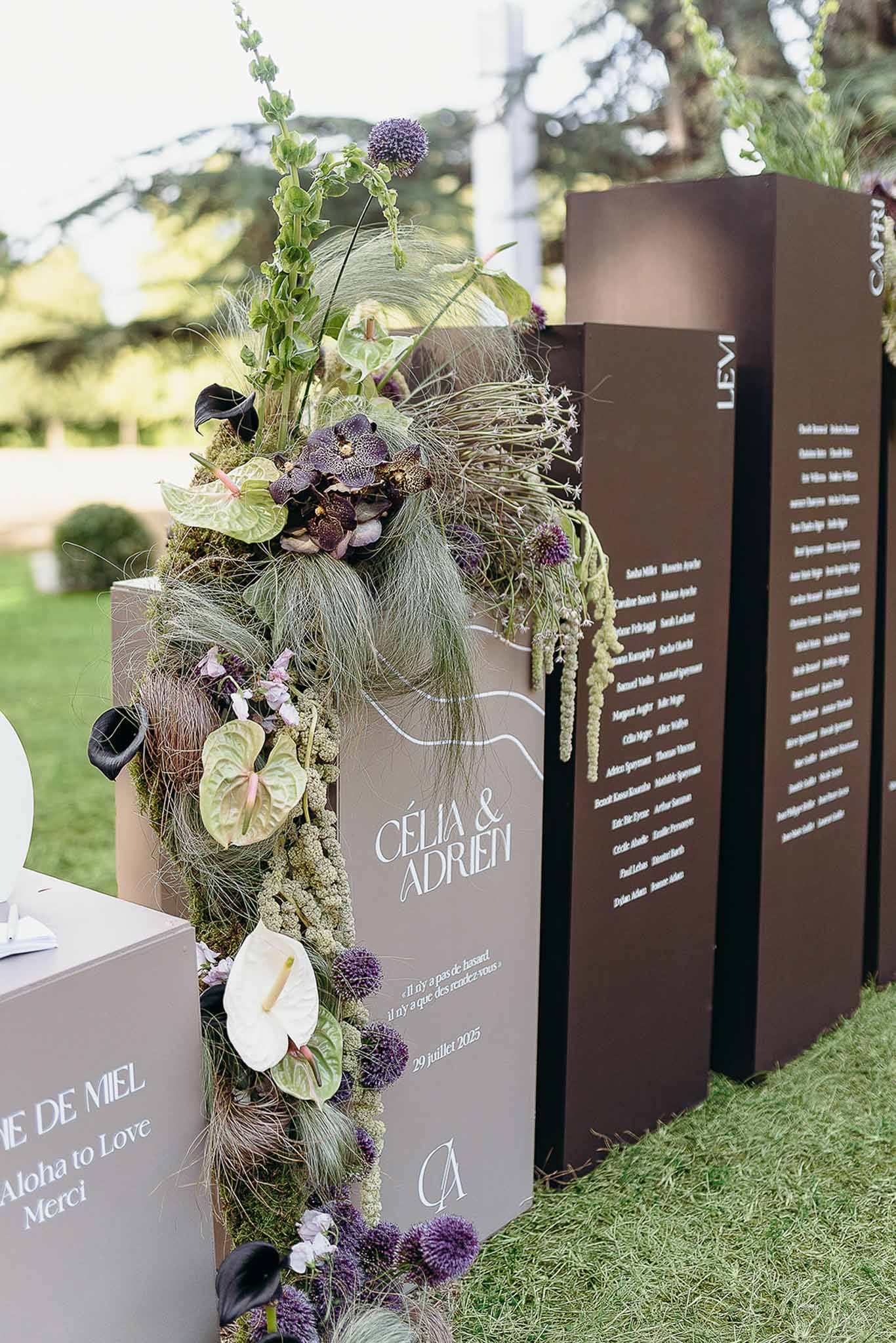 Seating arrangement displayed on engraved boxes with floral decor at Domaine de Perrotin