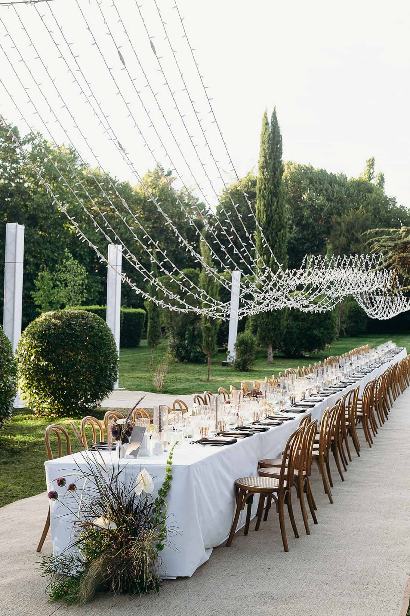Floral arrangement at the end of the long tablescape with string lights at Domaine de Perrotin