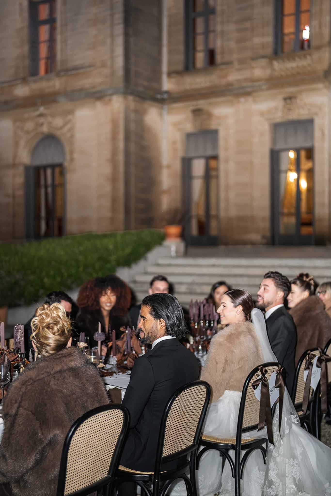 Evening reception dinner in front of Chateau du Terral with seated guests