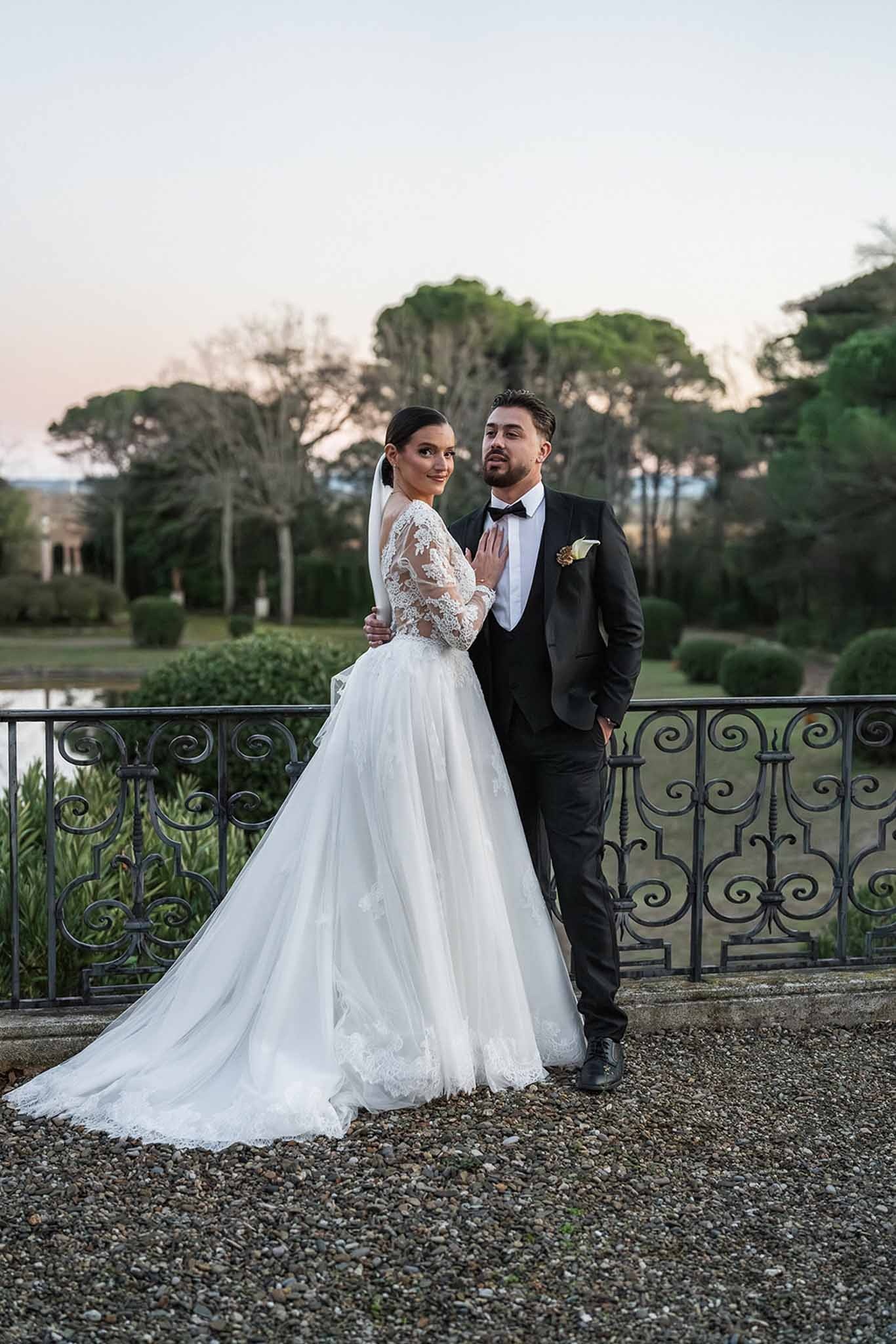 Couple portrait on balcony at dusk at Chateau du Terral with garden view