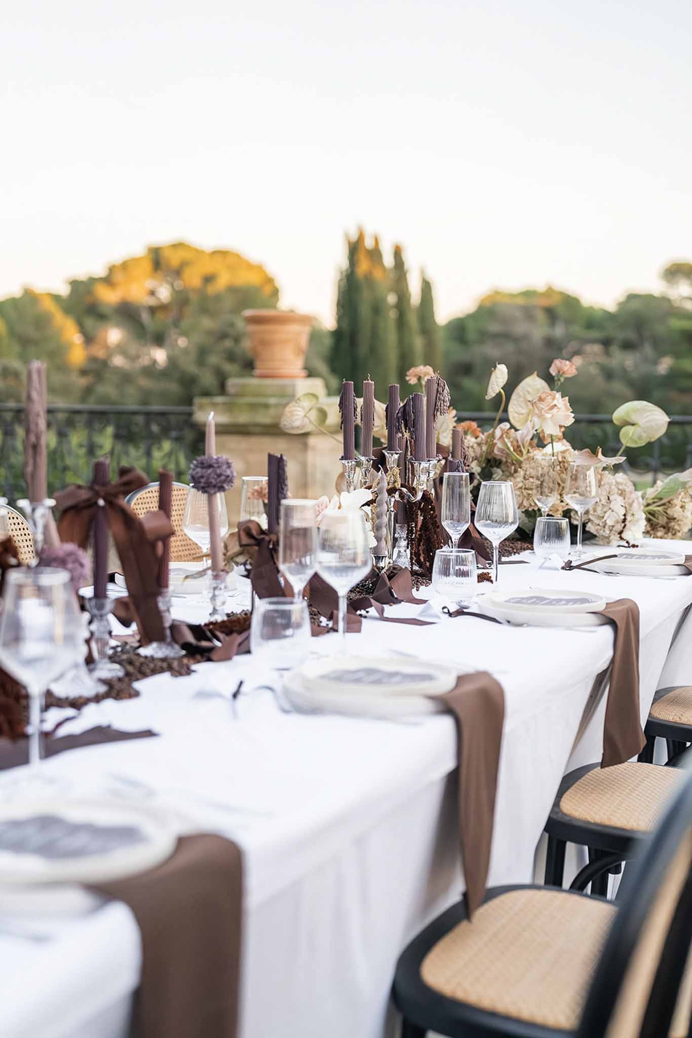 Long reception table on terrace at golden hour at Chateau du Terral
