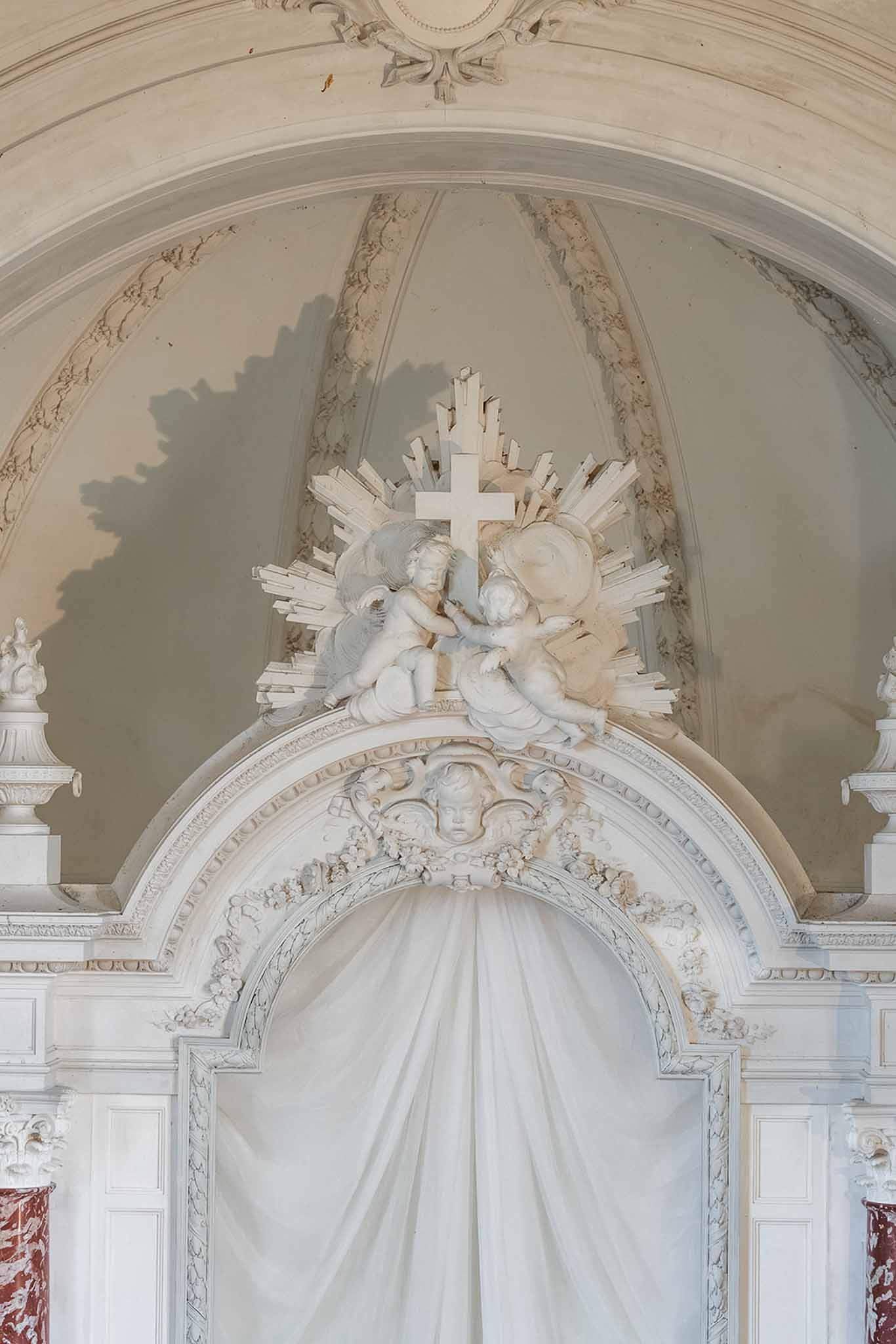 Baroque chapel ceiling with cherubs and cross at Chateau du Terral