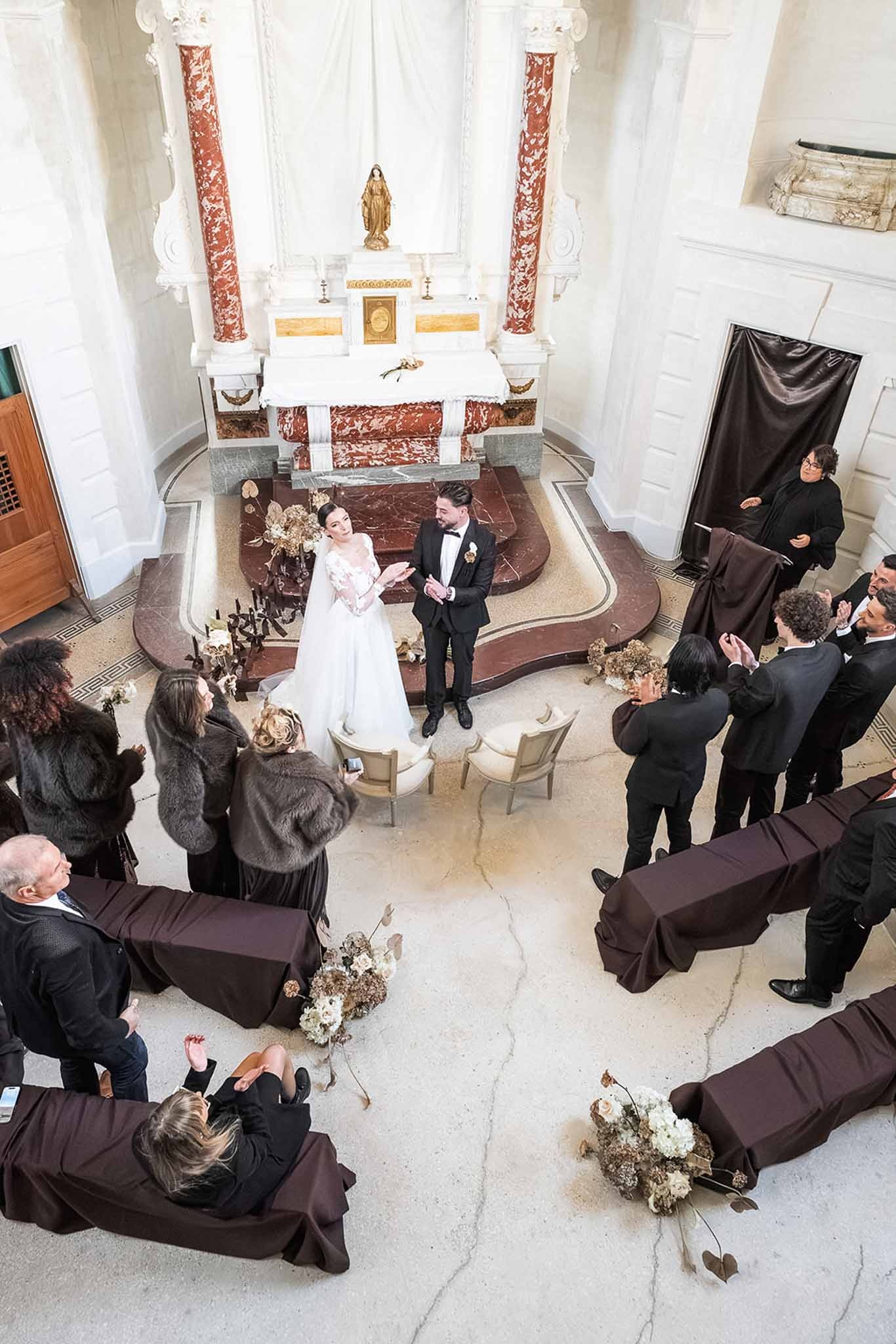 Overhead view of chapel ceremony with guests applauding at Chateau du Terral