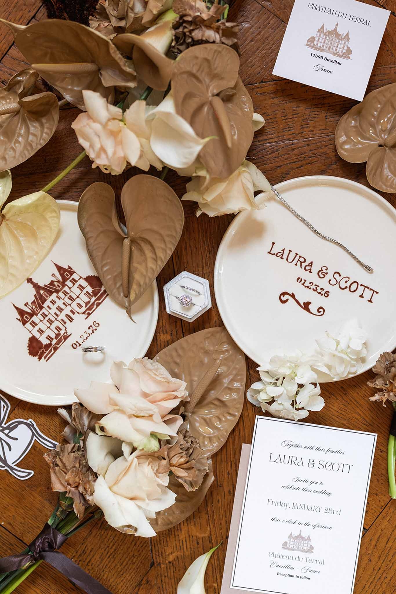 Wedding stationery flatlay with custom plate and ring box at Chateau du Terral
