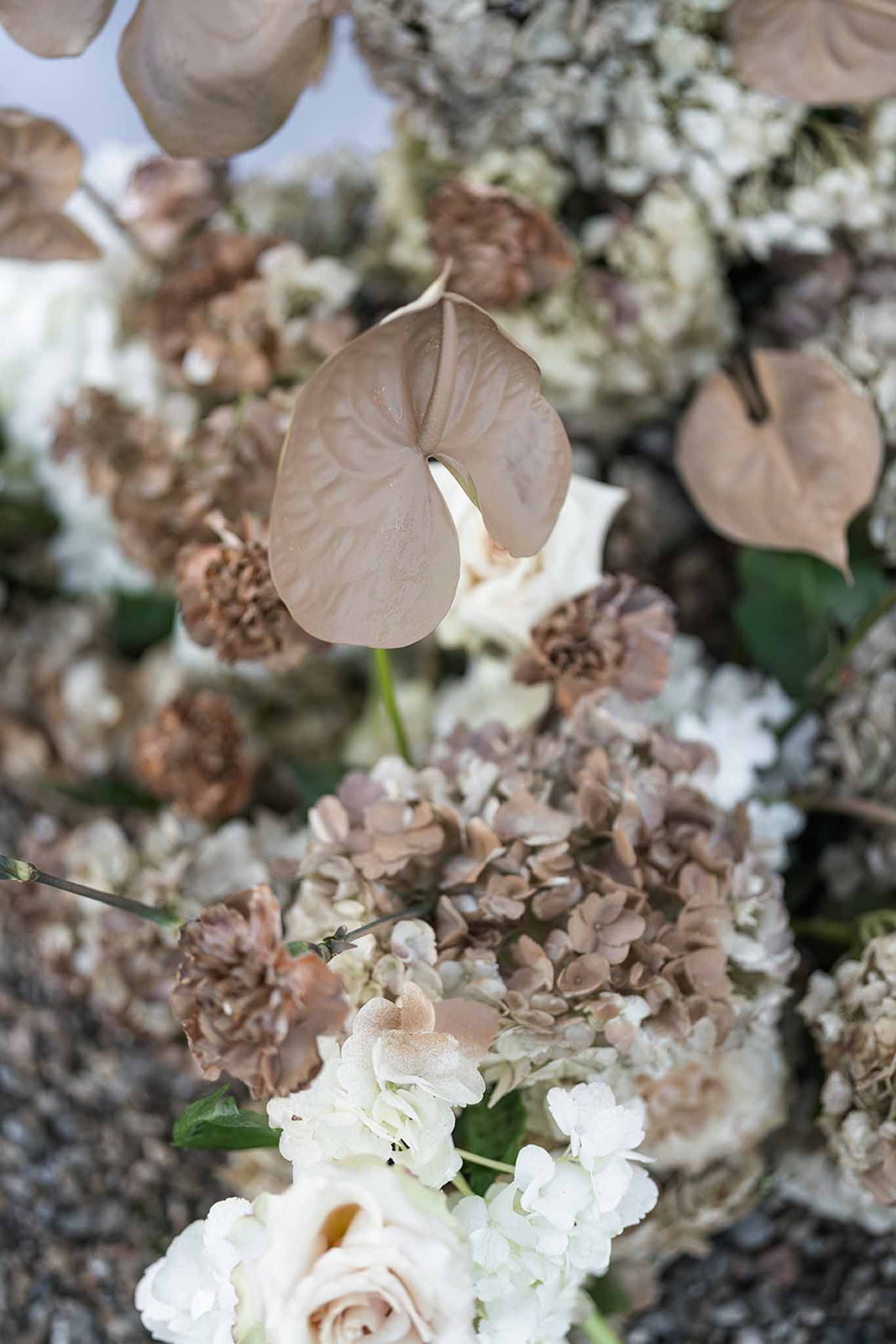 Dried floral arrangement with gold anthurium and blush roses at Chateau du Terral