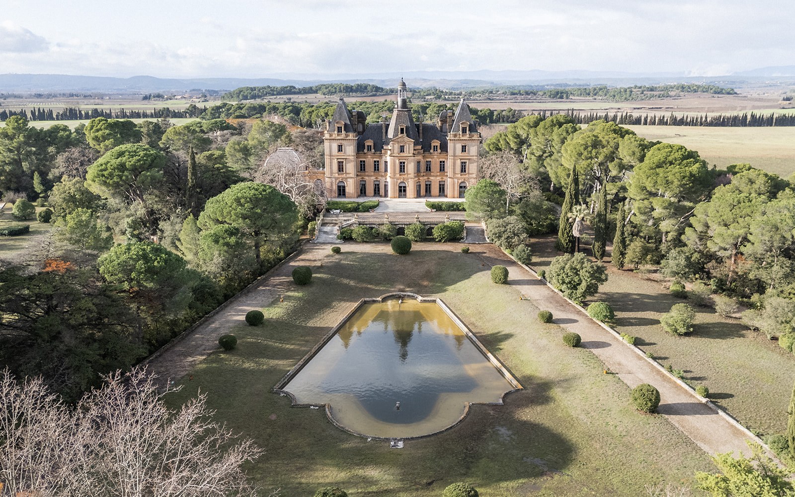 Aerial view of Chateau du Terral with rectangular reflecting pool and parterre at Chateau du Terral