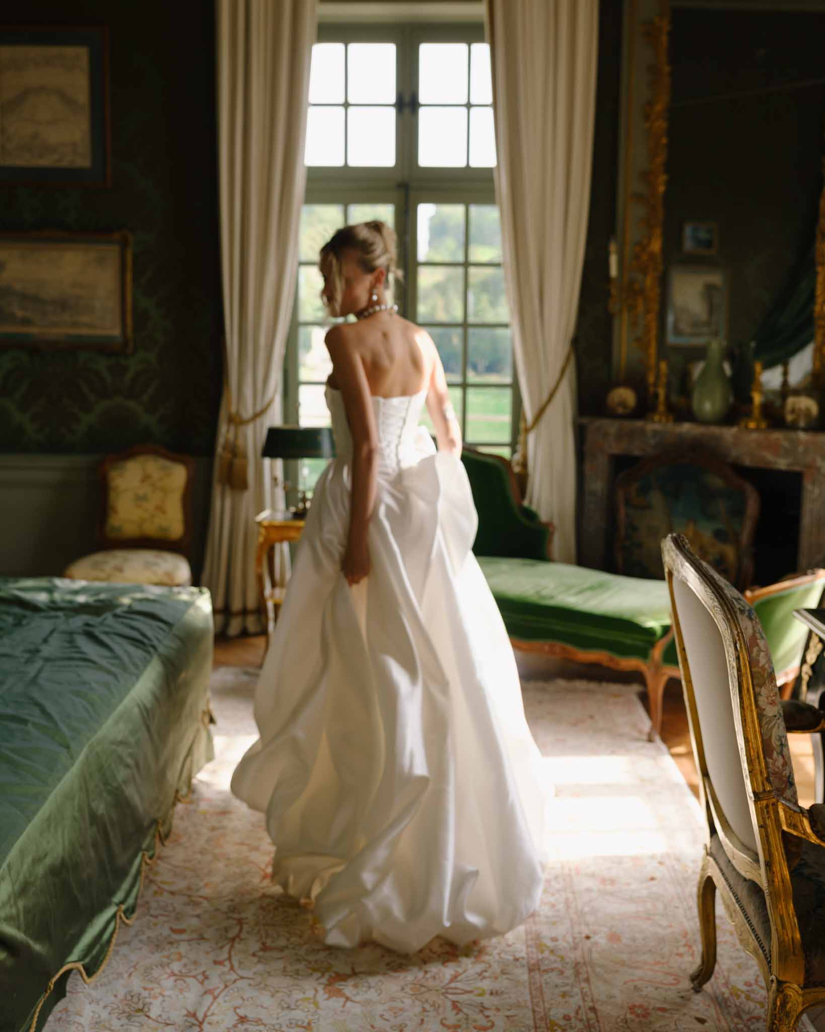 Bride in motion running through the chateau's halls, dress flowing behind