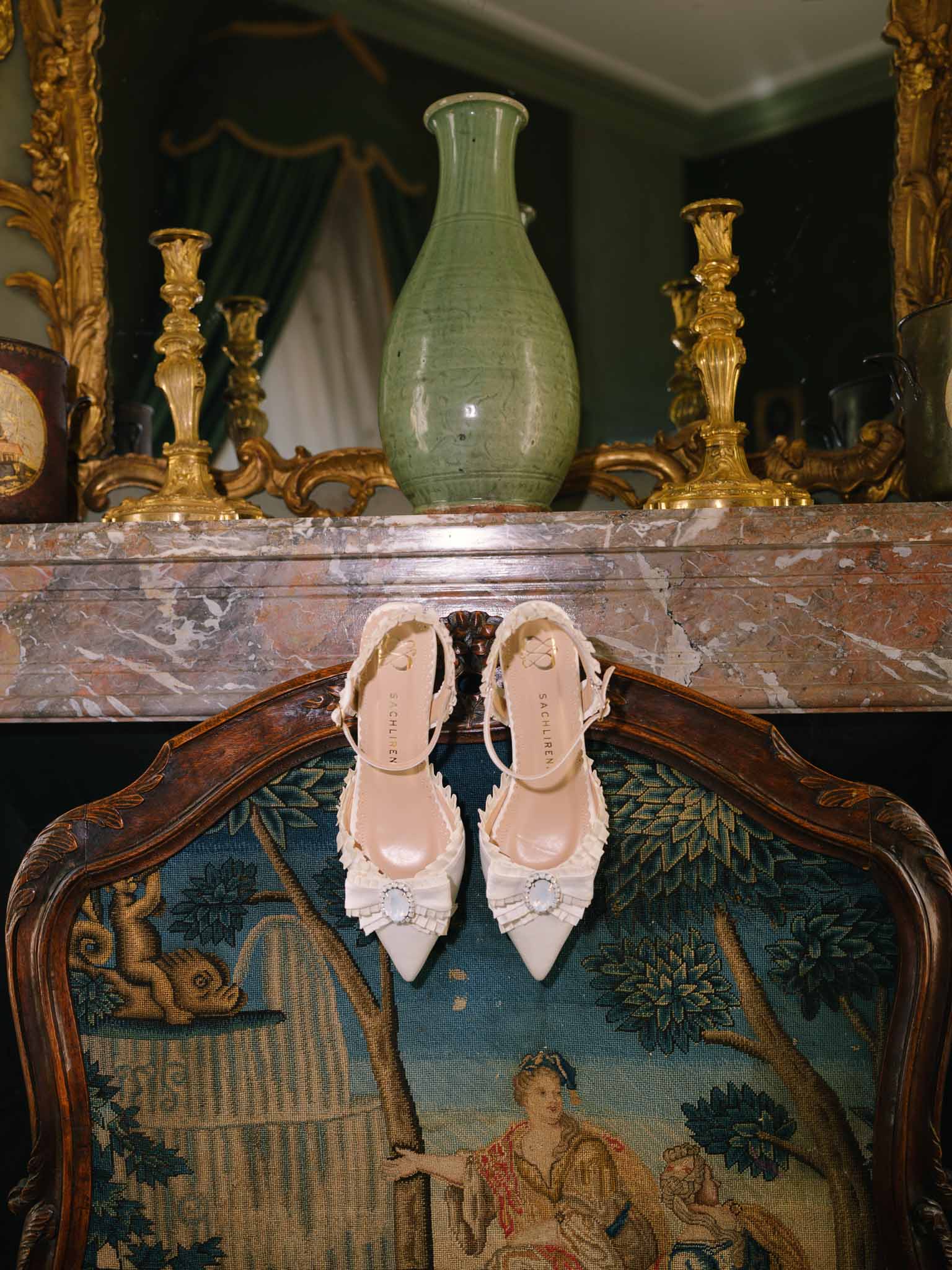 Pointed bridal shoes by Sachlirene hanging on vintage chair
