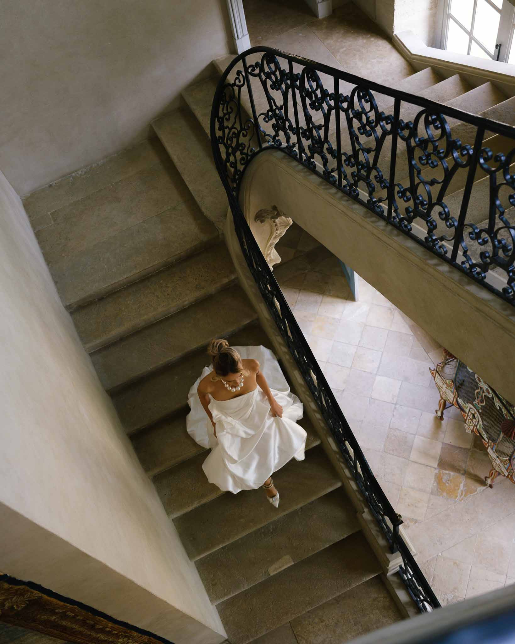 Bride walking down the grand staircase at Chateau de Villette