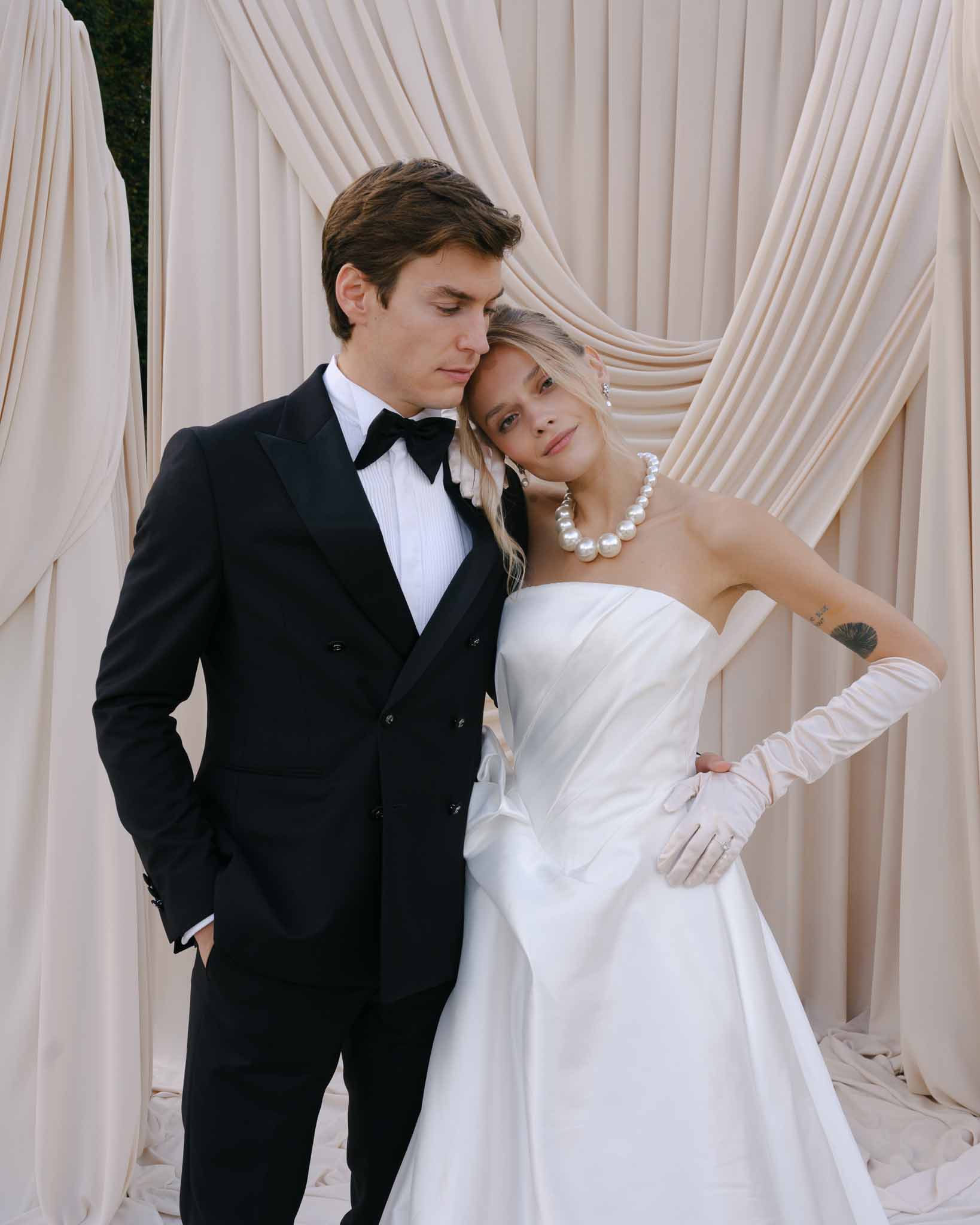 Bride resting her head on groom's shoulder during ceremony