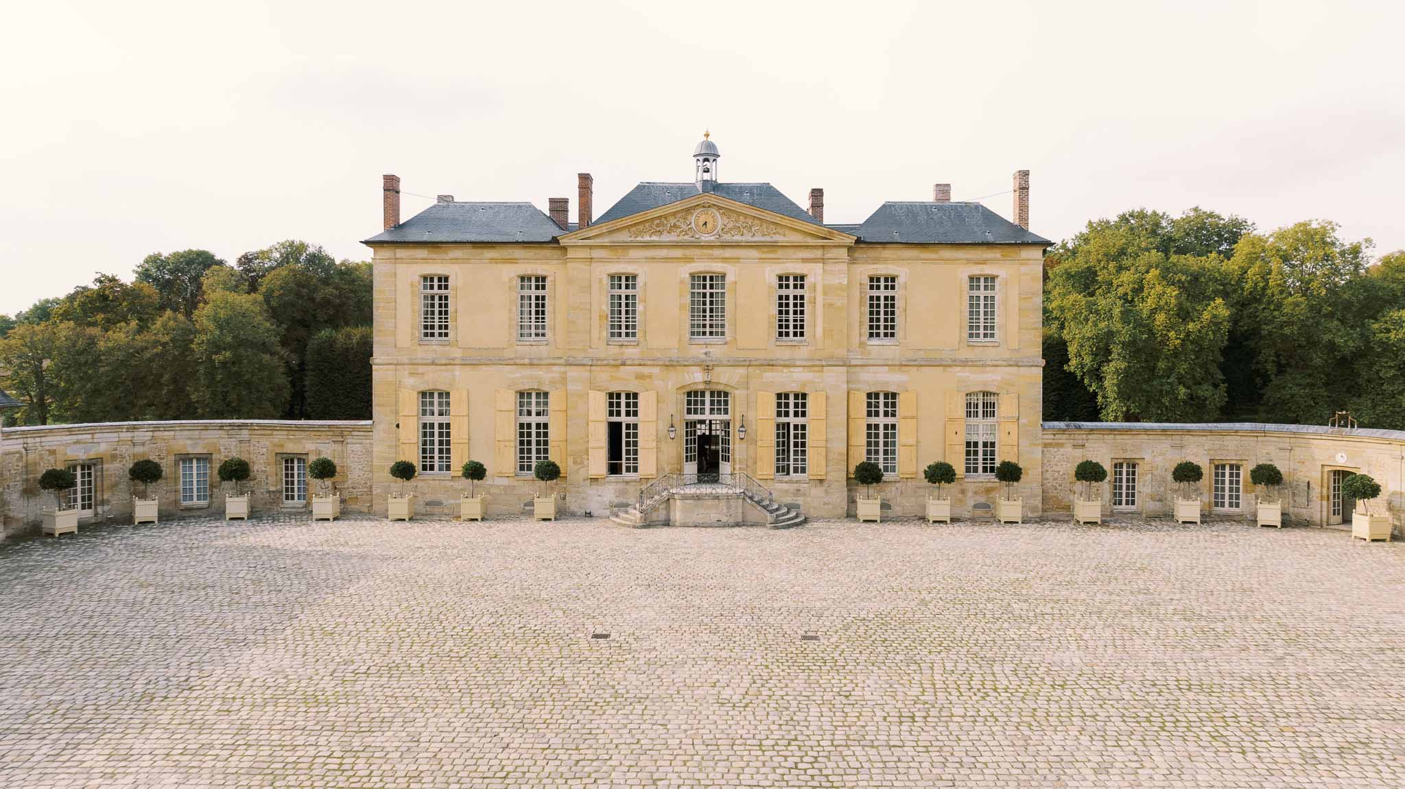 Side view of Chateau de Villette showing brick wall and grounds