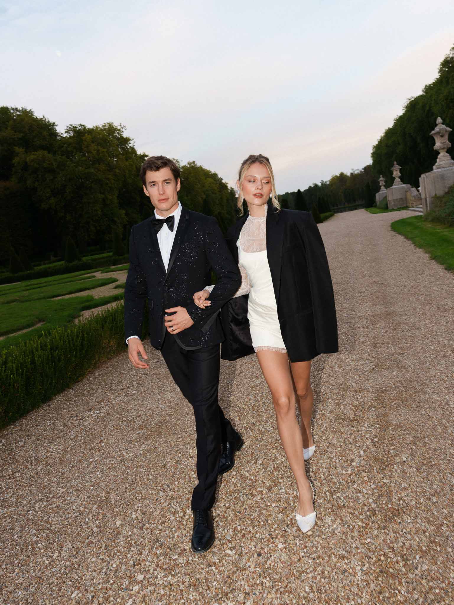 Couple walking in after-party evening attire at the reception