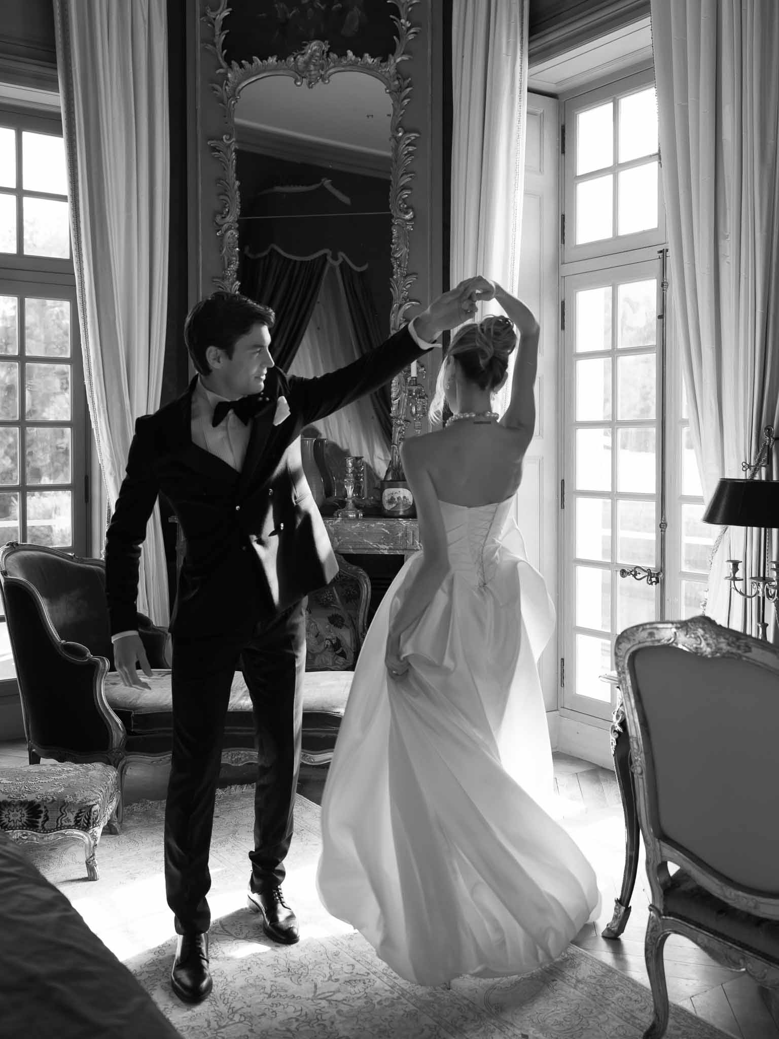 Couple sharing a playful twirl dance in the period room