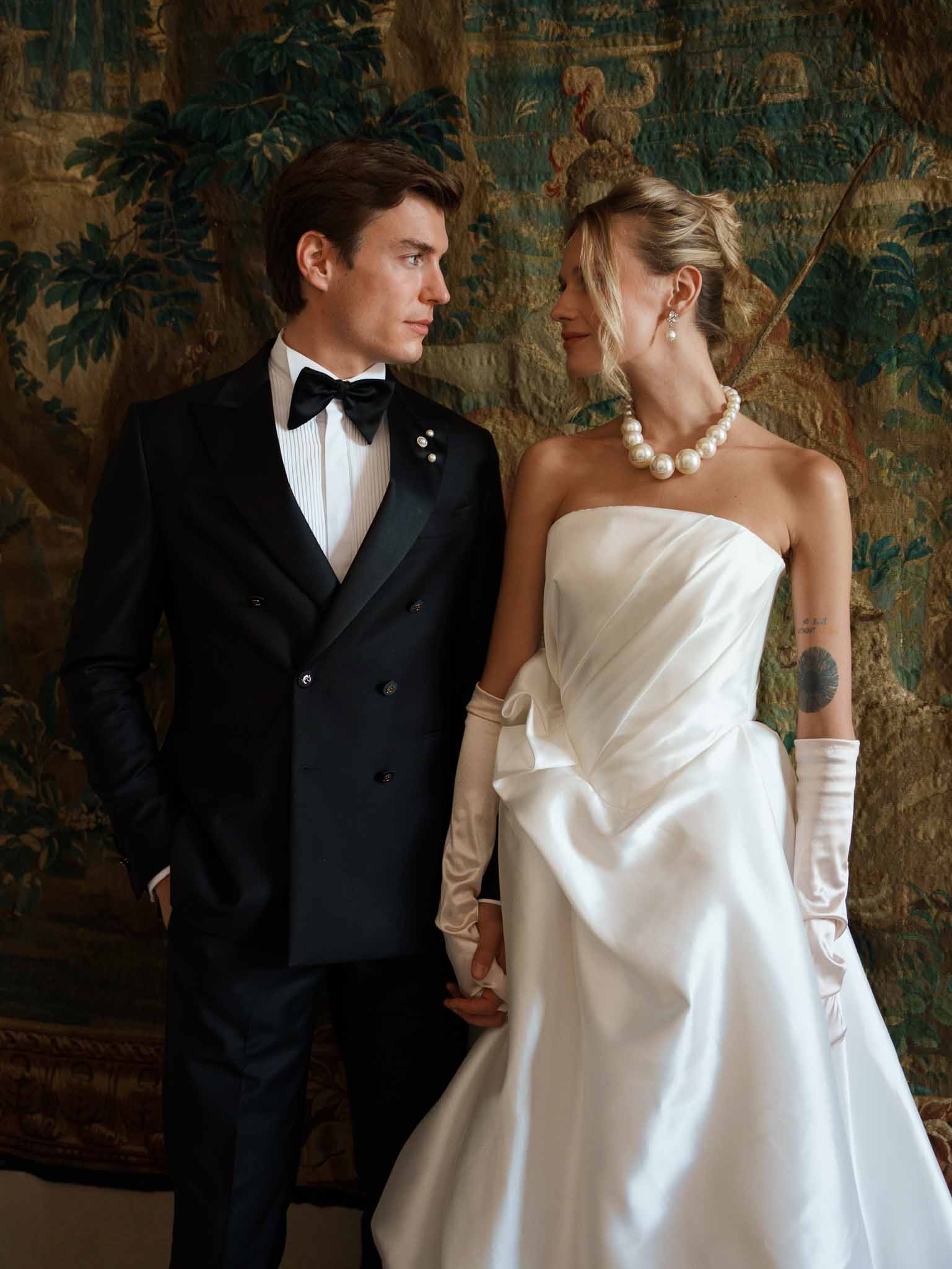 Couple holding hands and gazing at each other in the chateau