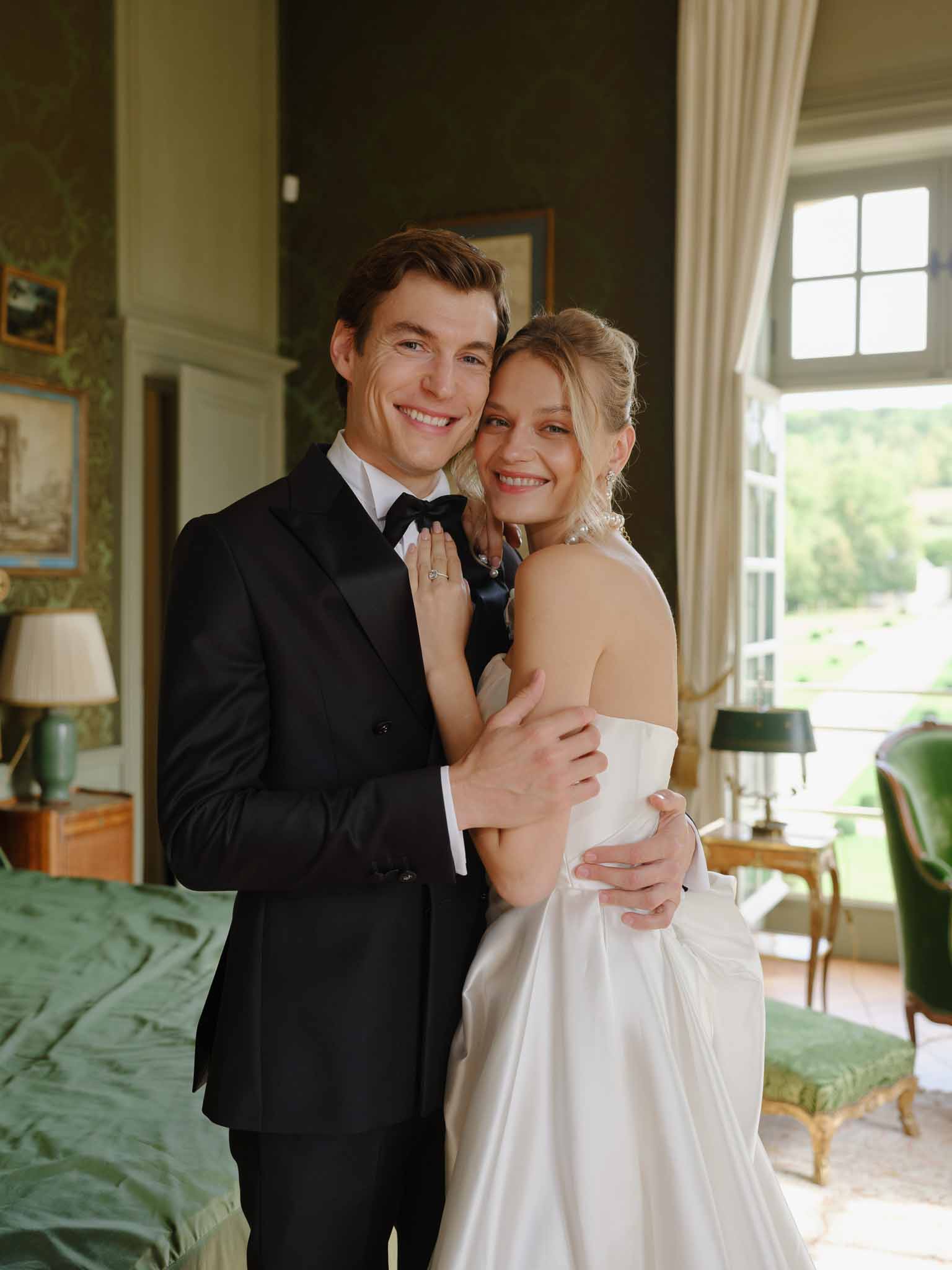 Couple in a close embrace in the chateau's vintage-furnished room
