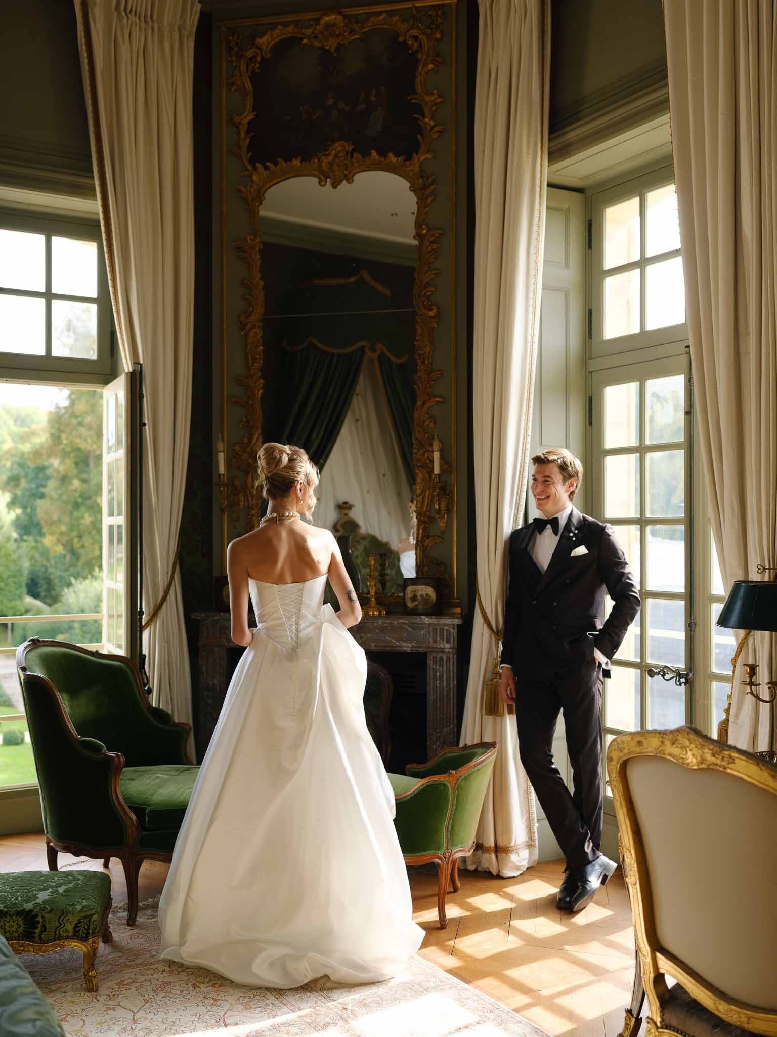 Couple gazing at each other in ornate period room at Chateau de Villette