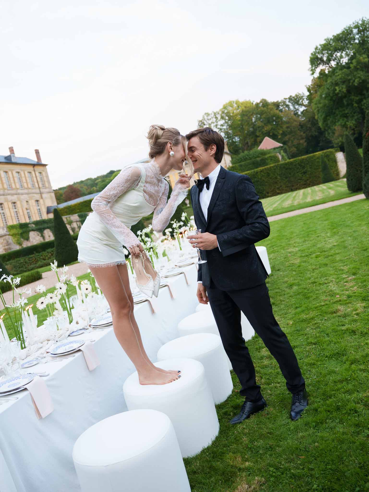 Couple sharing a kiss at the beautifully set reception table