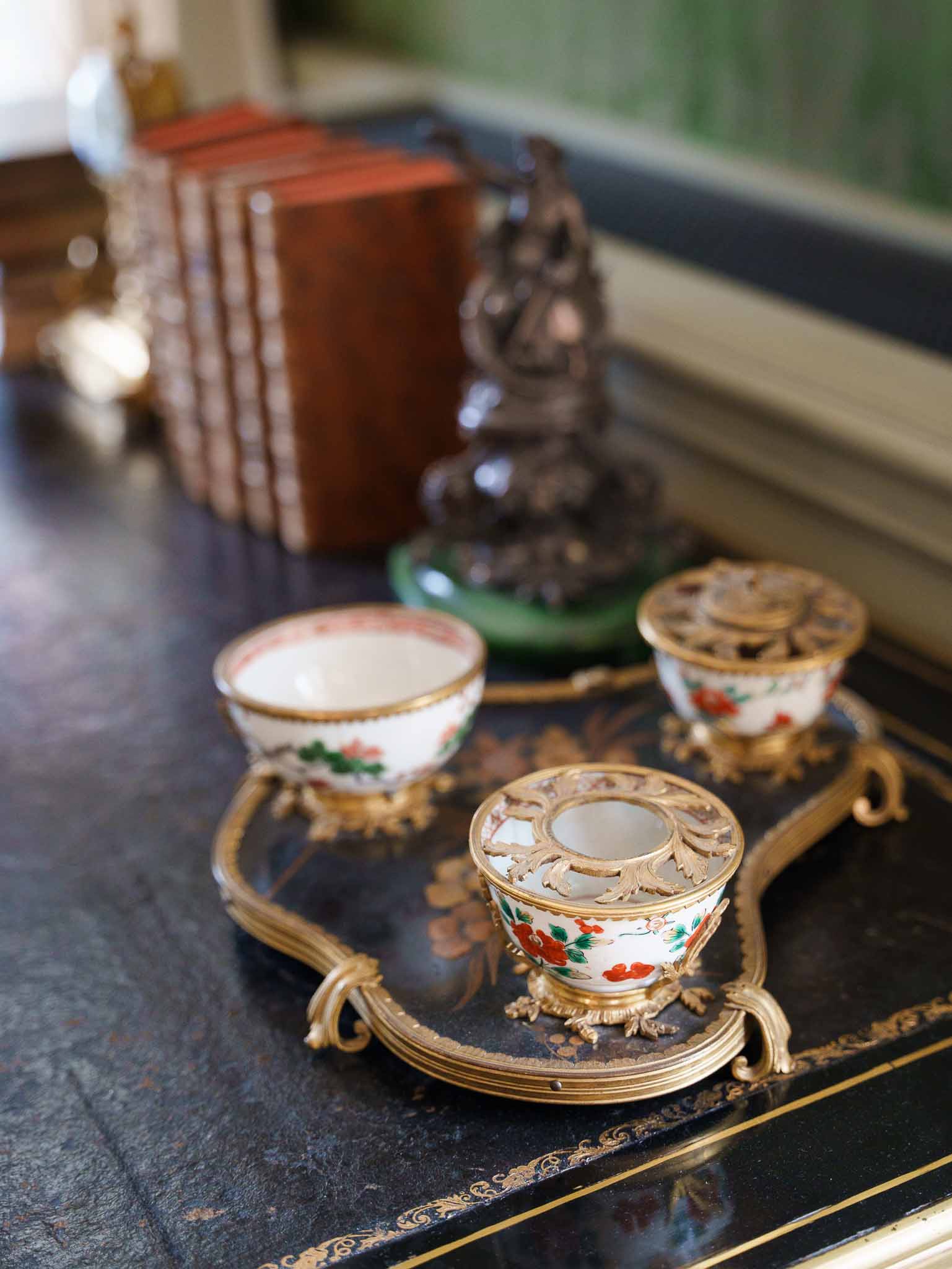 Vintage porcelain tea set arranged on a silver tray