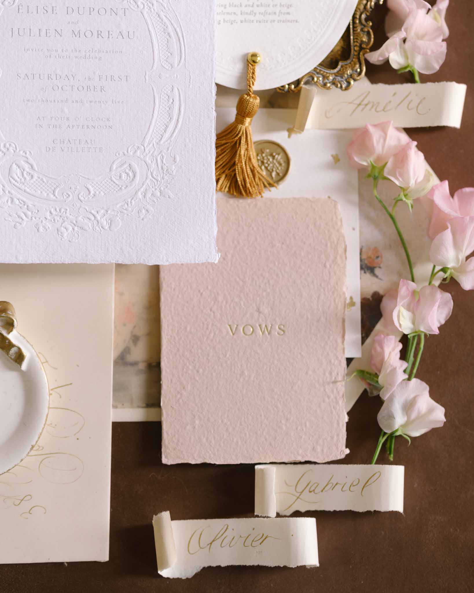 Wedding invitation flatlay with gold accents and vintage styling